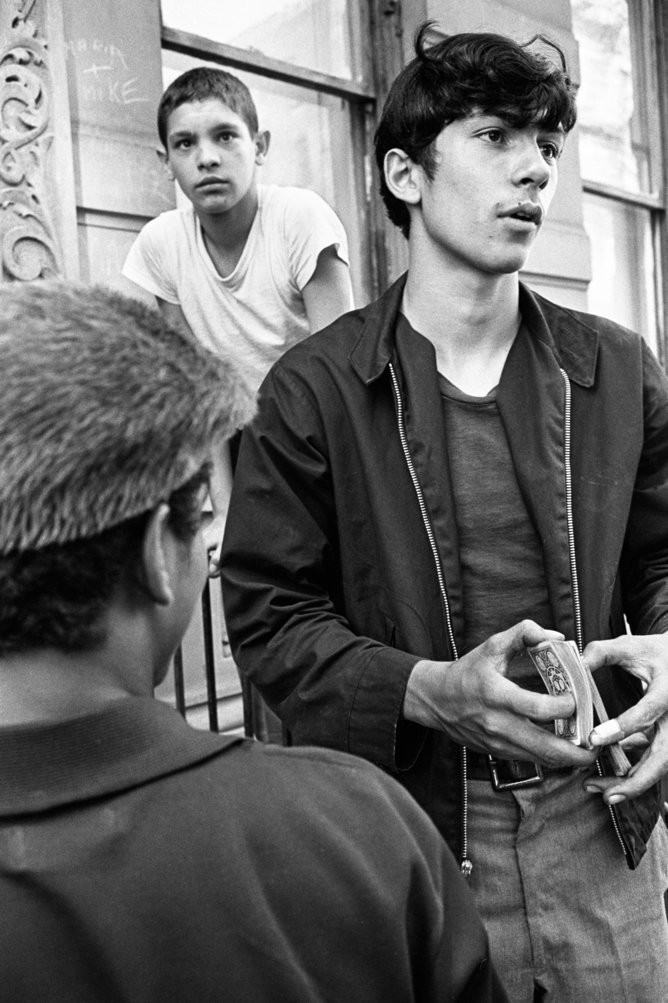 black and white photo of three teenagers on steps