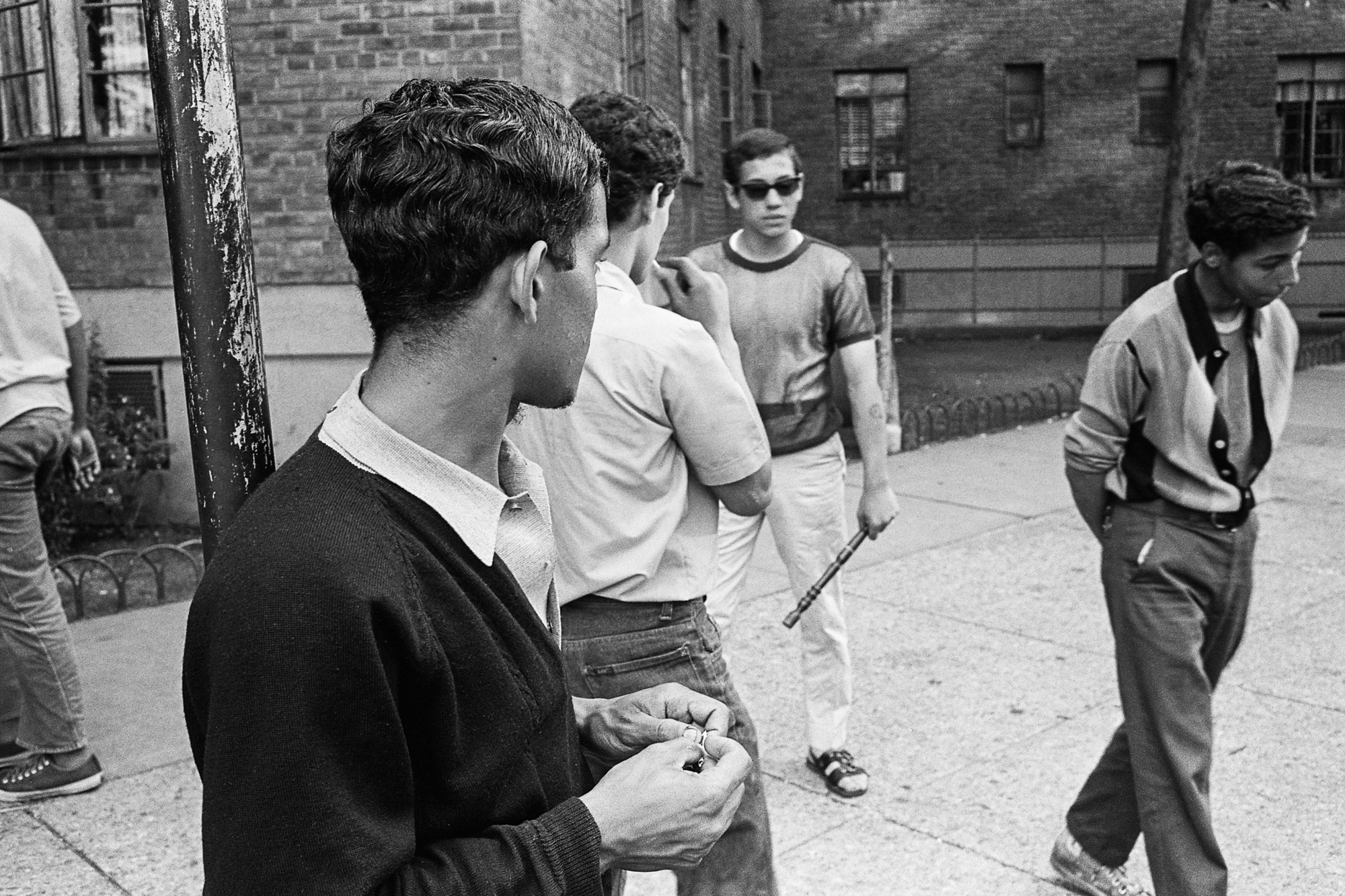 black and white photo of four teenage boys hanging out