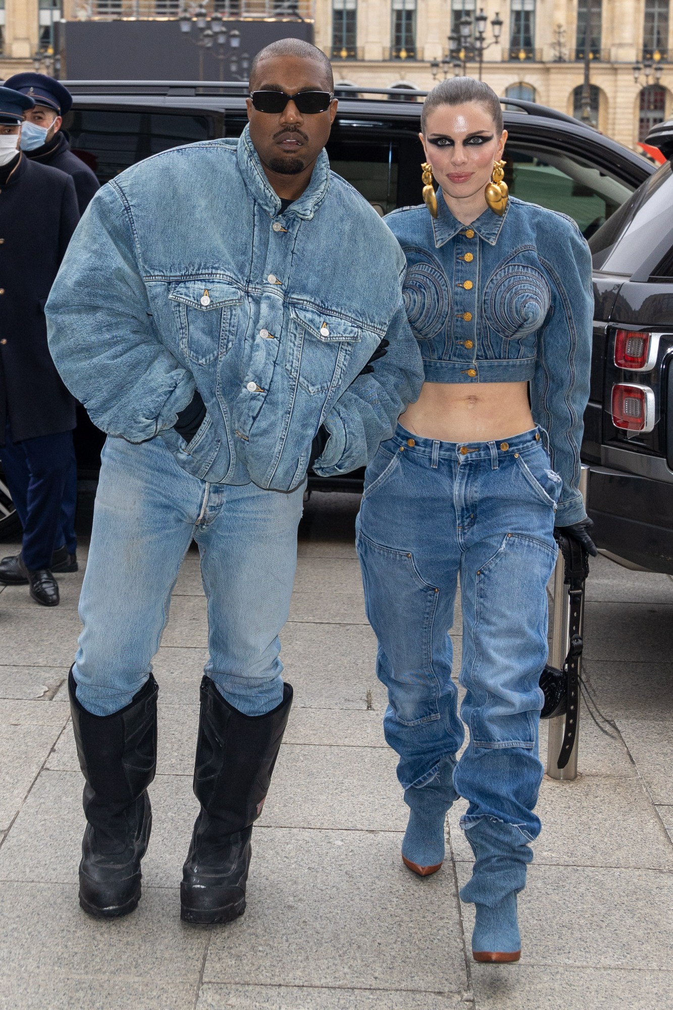 Julia Fox with Kanye in double denim looks at the Kenzo AW22 show in 2022.