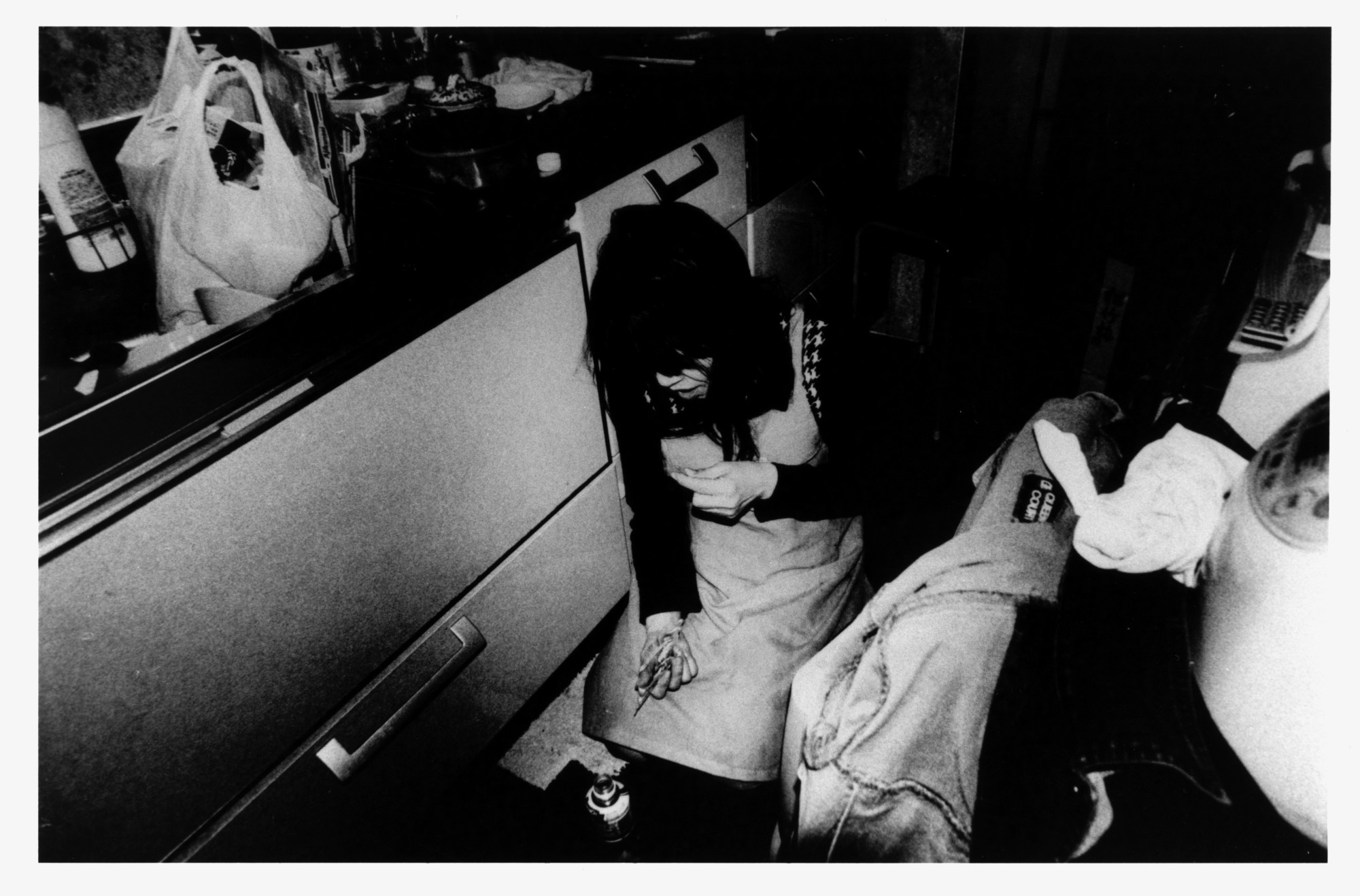 a woman on the floor of her kitchen