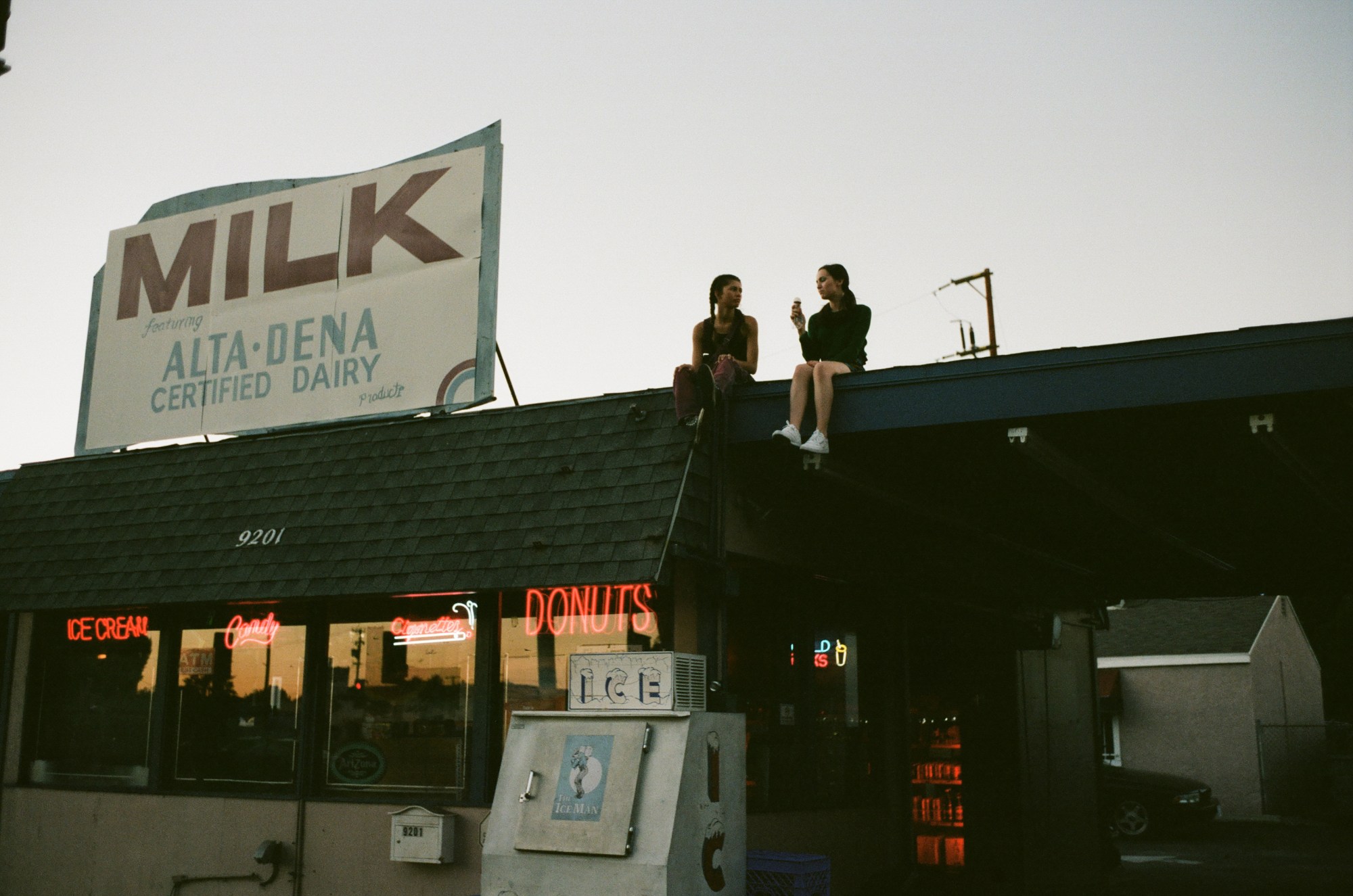 Zendaya and Maude Apatow sit on the roof on set of Euphoria