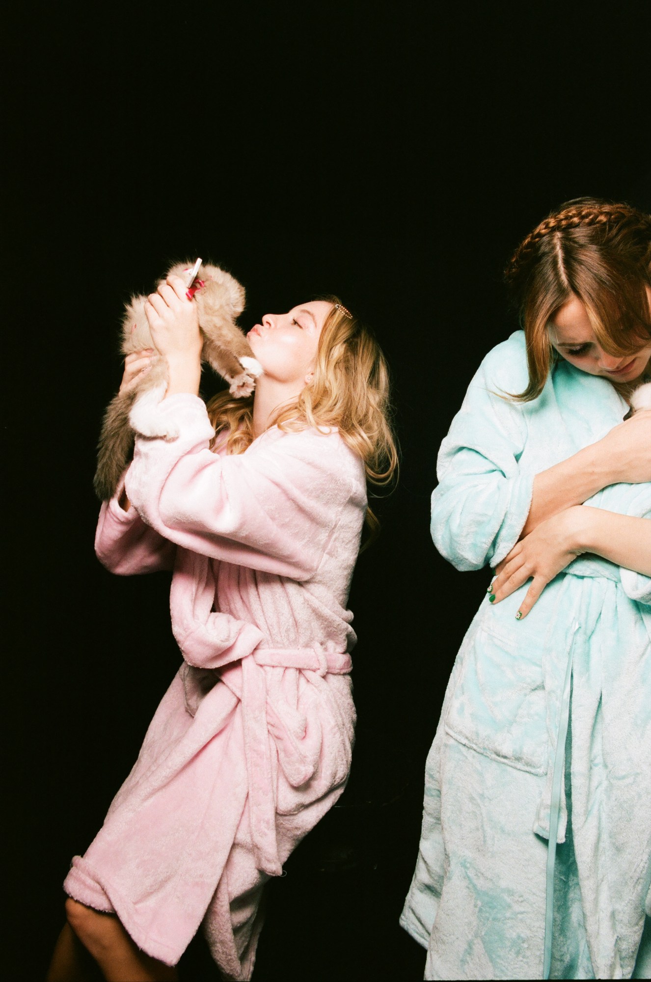 Sydney Sweeney and Maude Apatow cuddling animals in dressing gowns