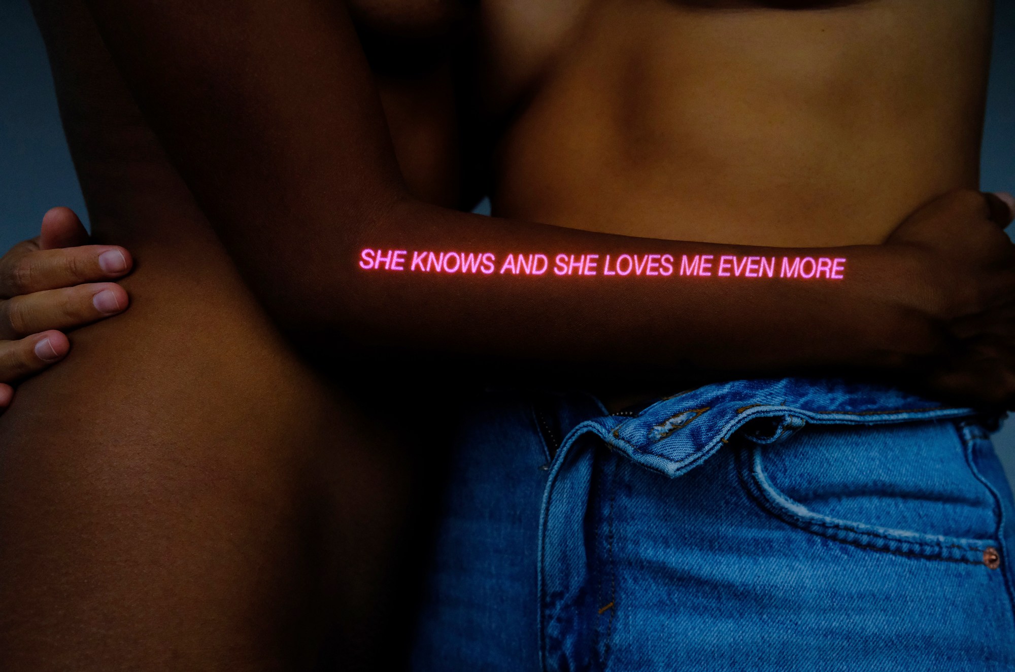 portrait of two lovers embracing overlaid with text by kia labeija