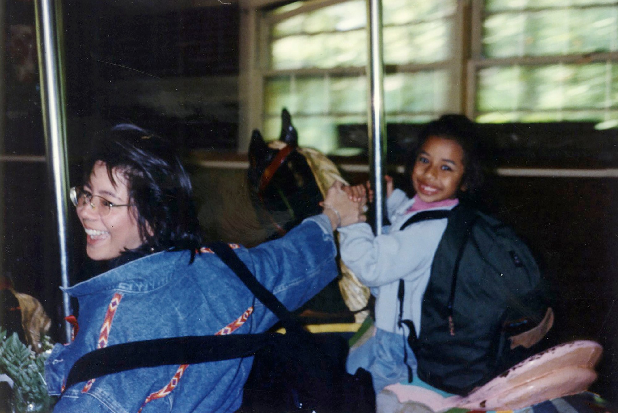 a photo of kia labeija and her mother on a carousel in the 90s