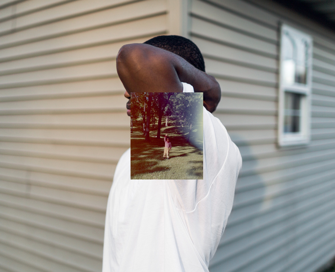 Image of man in a white t-shirt overlayed with an old family photo