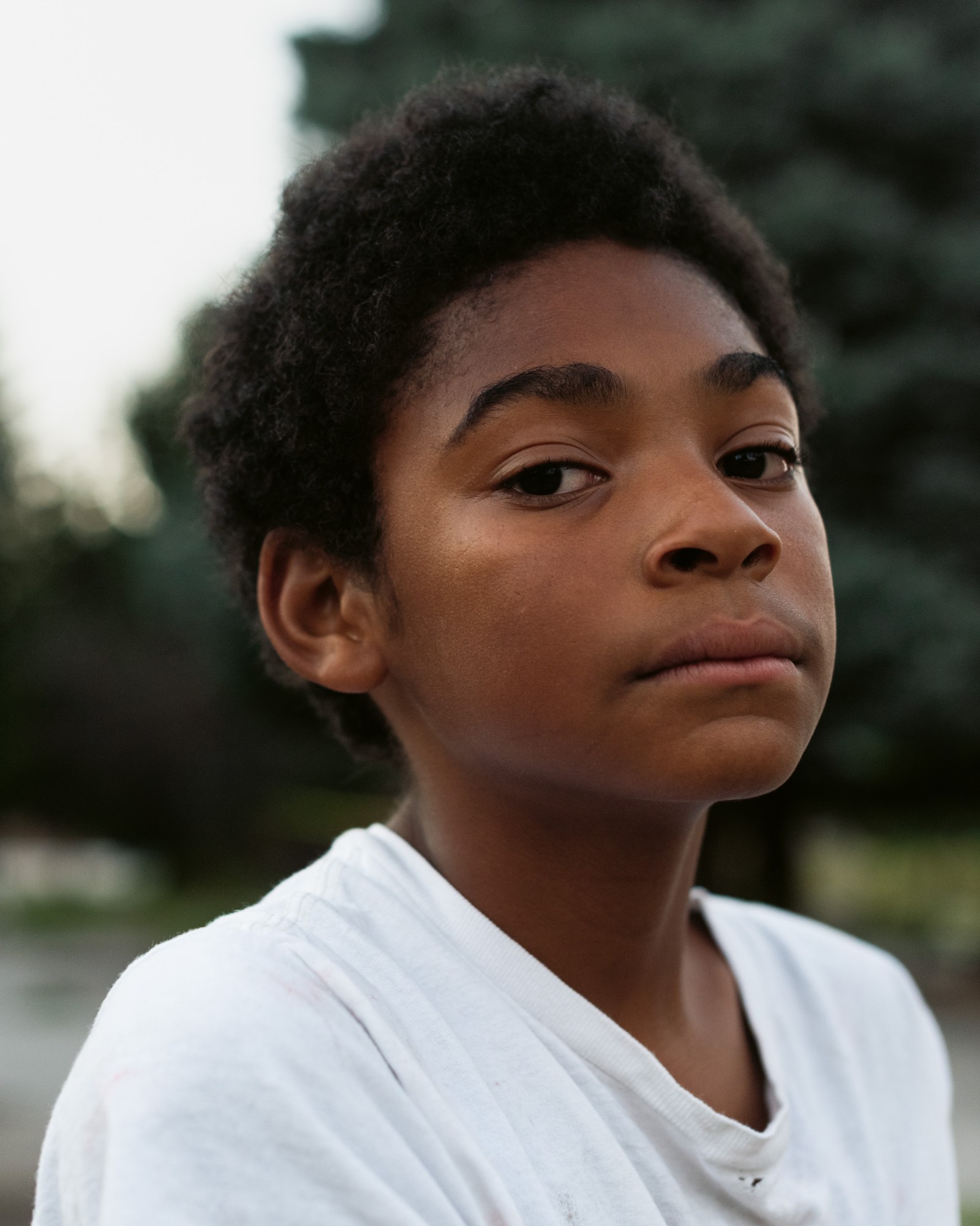 Portrait of a young boy wearing a white t-shirt