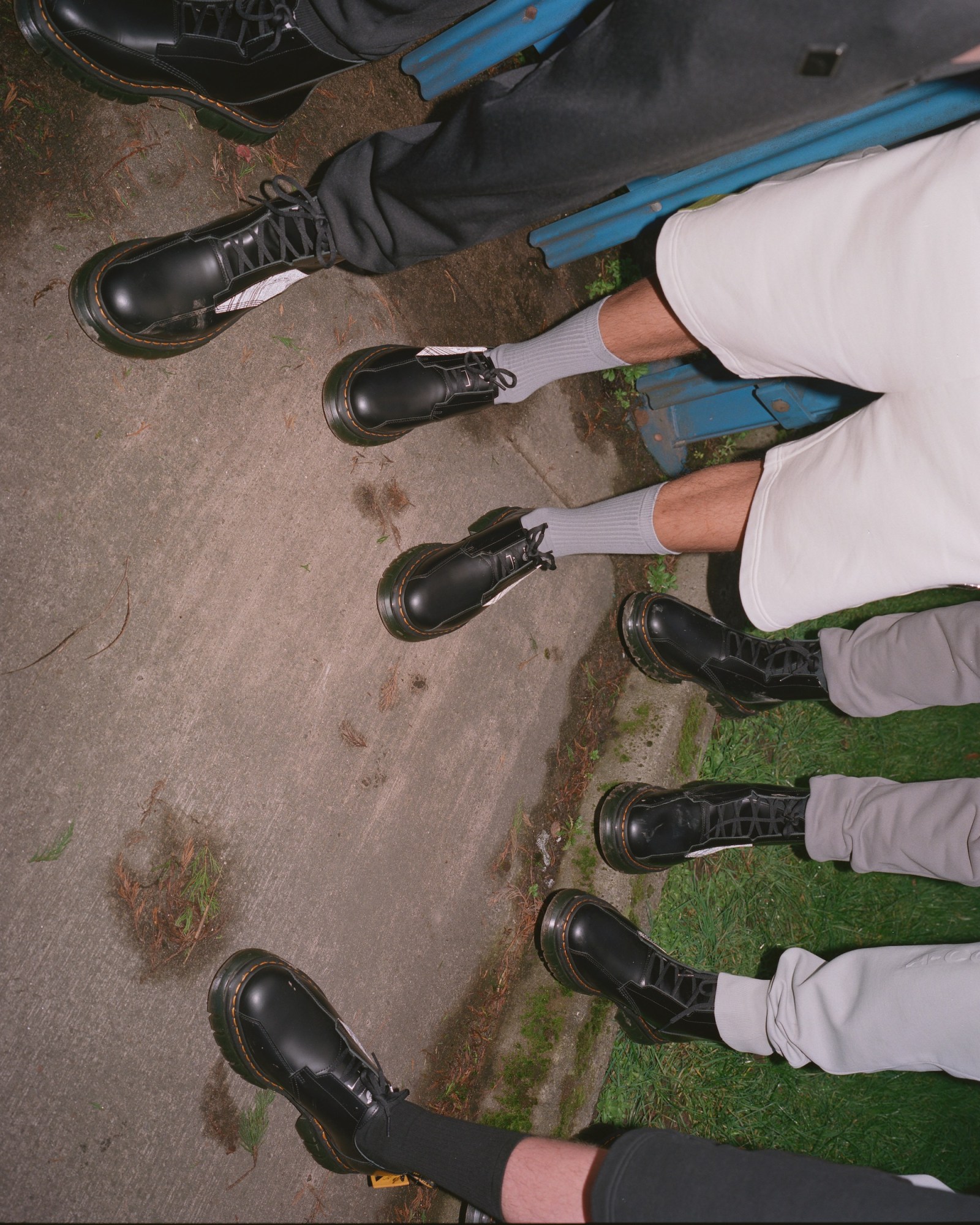 a line-up of feet wearing dr martens