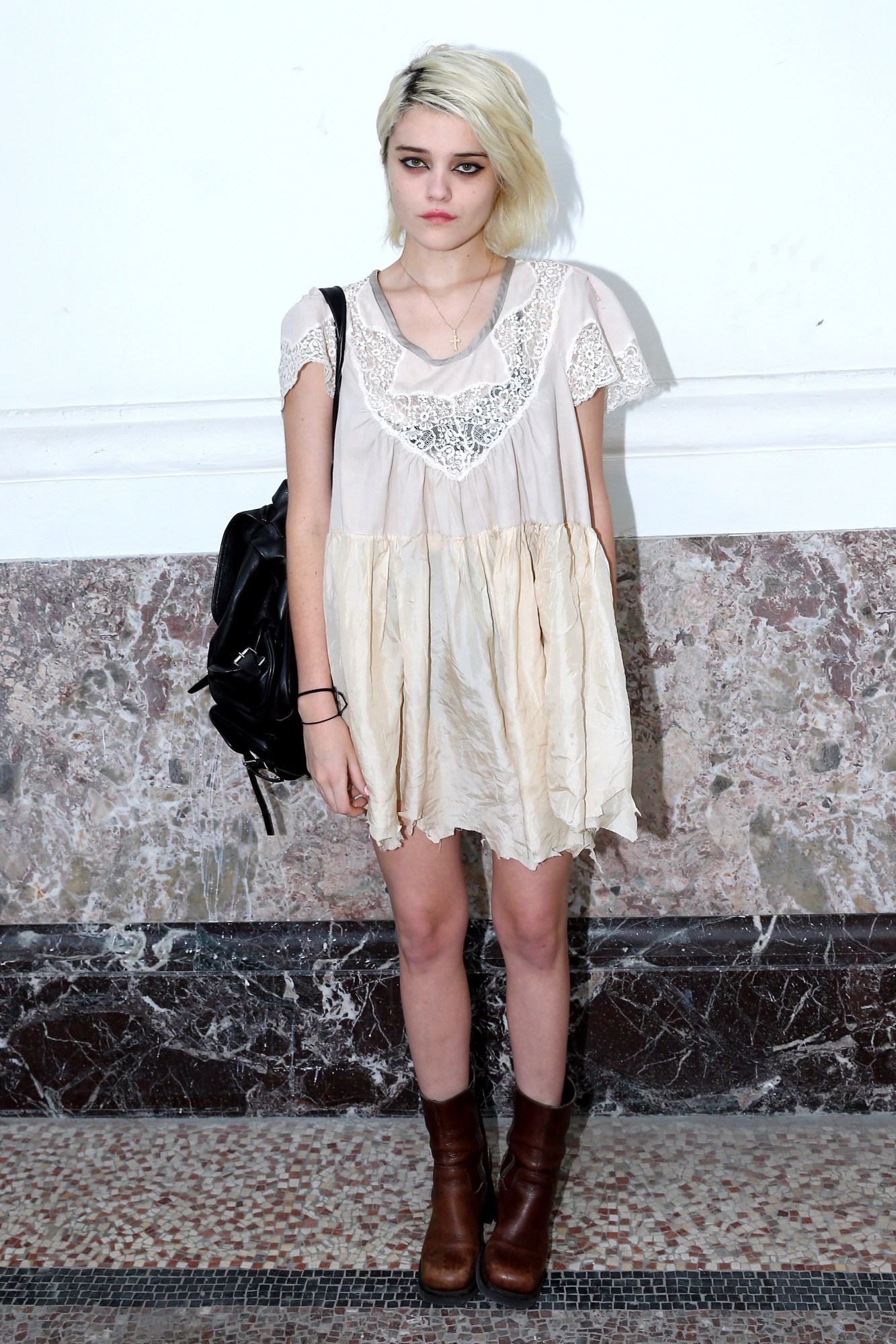 sky ferreira waring a white babydoll dress and boots at a saint laurent show in paris in 2013