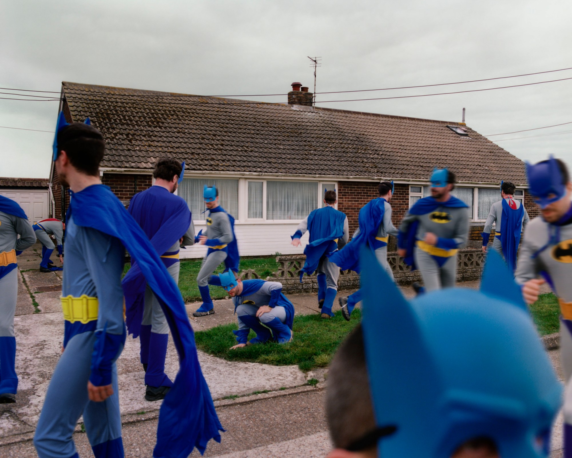 batman cosplayers outside a suburban home by thurstan redding