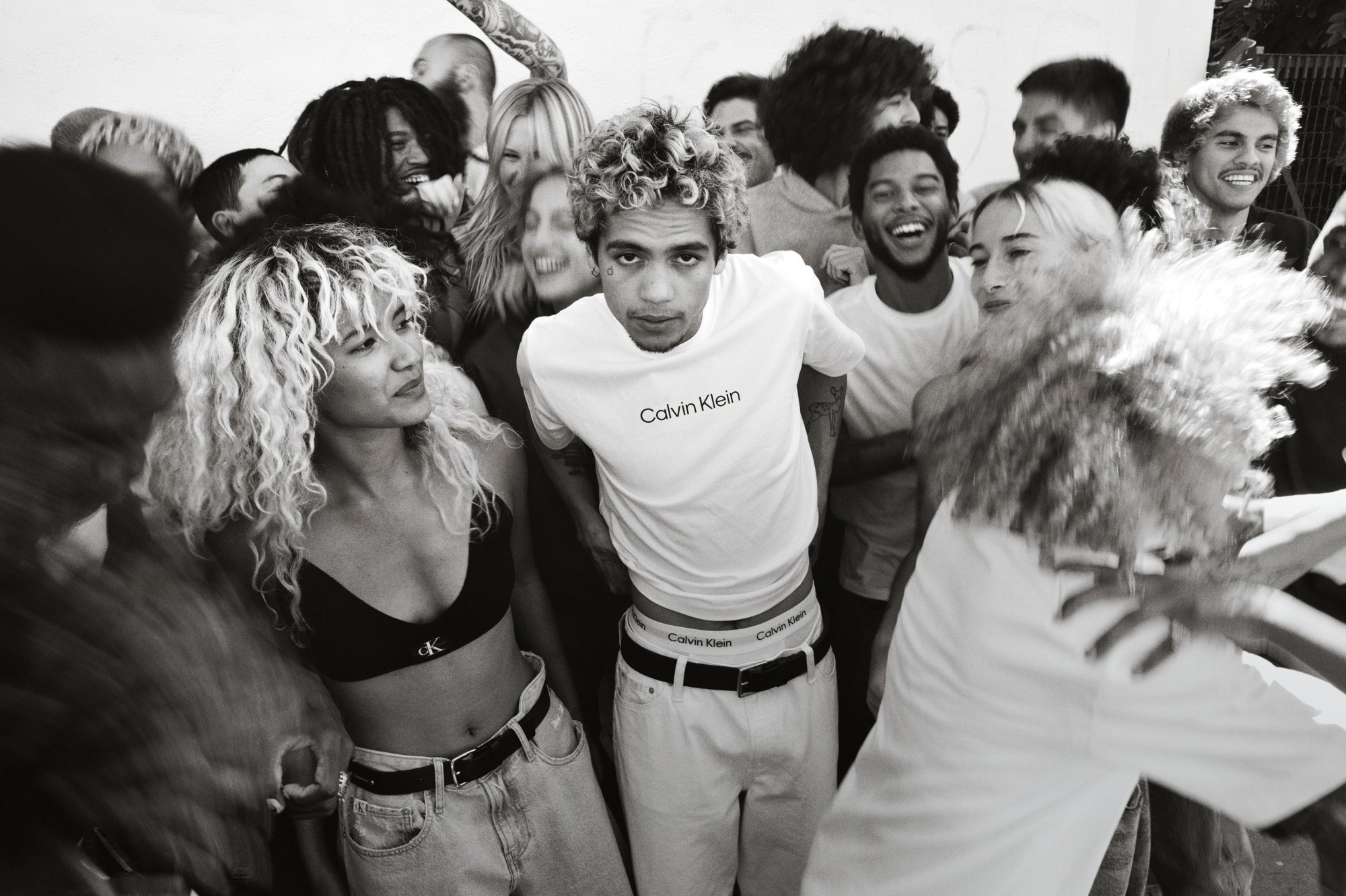 Dominic Fike and a group of models wearing Calvin Klein and dancing