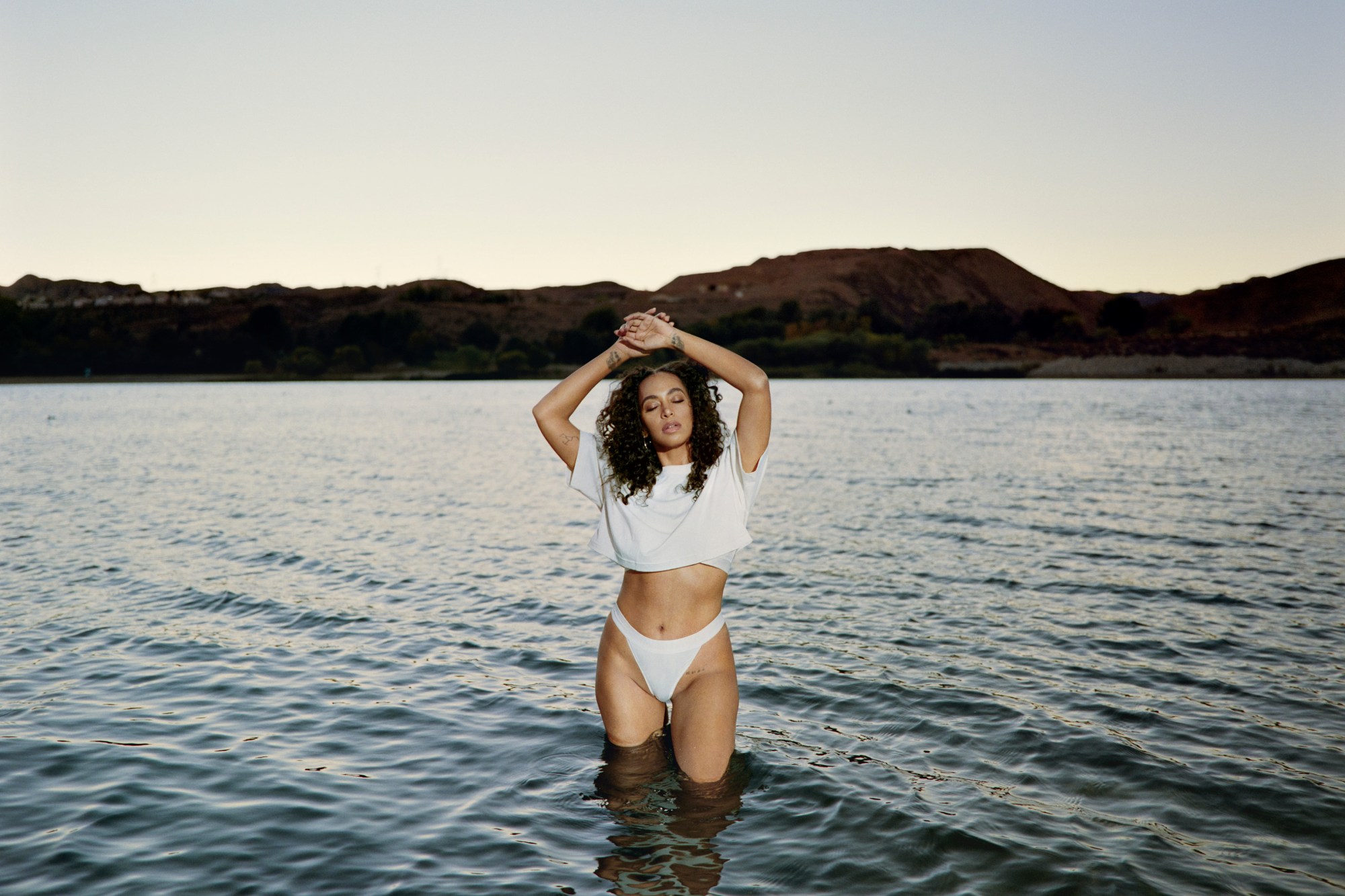 Solange wearing Calvin Klein crop top and briefs in a lake.