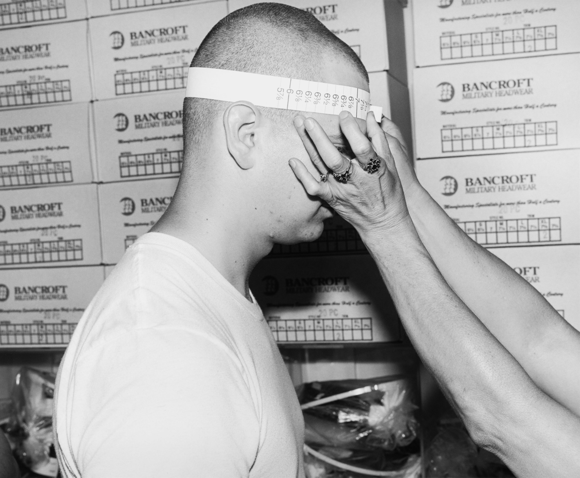 a young soldier being measured for a hat in pensacola florida by ken graves and eva lipman