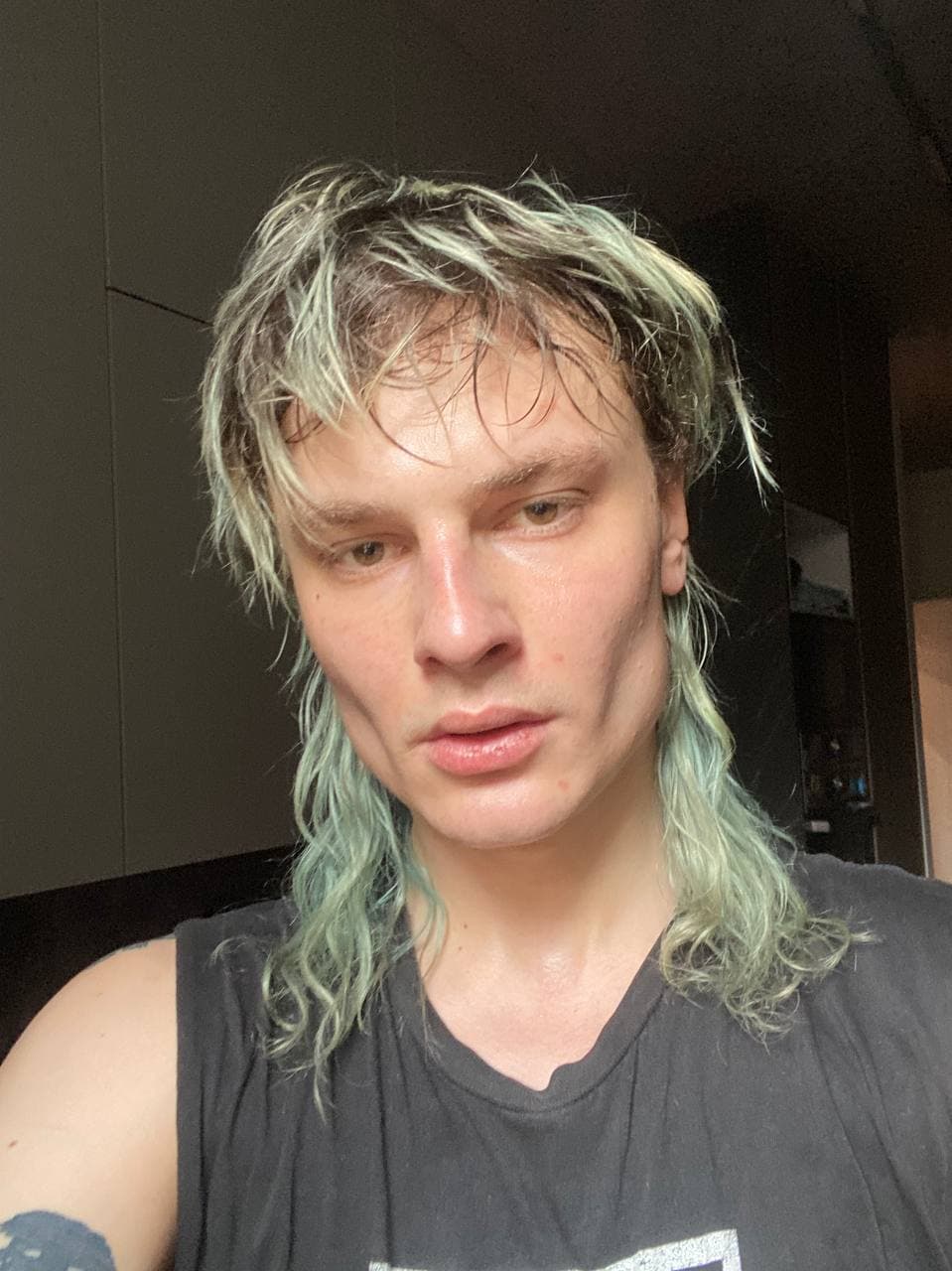 a selfie of a person with an aqua mullet