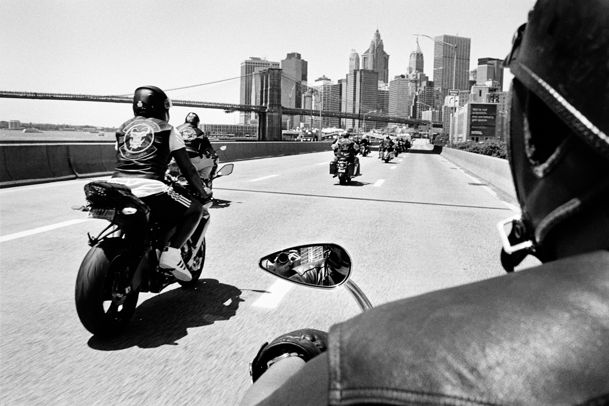 Self-portrait riding with an outlaw club on the FDR, the Brooklyn Bridge and downtown in the background, Manhattan 2017