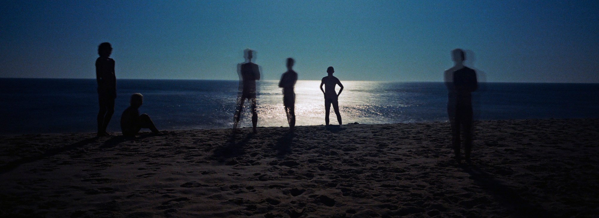 men on fire island beach