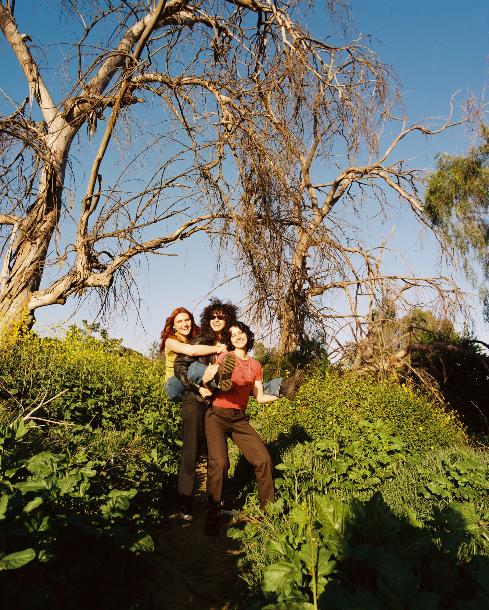 MUNA standing in a field in LA