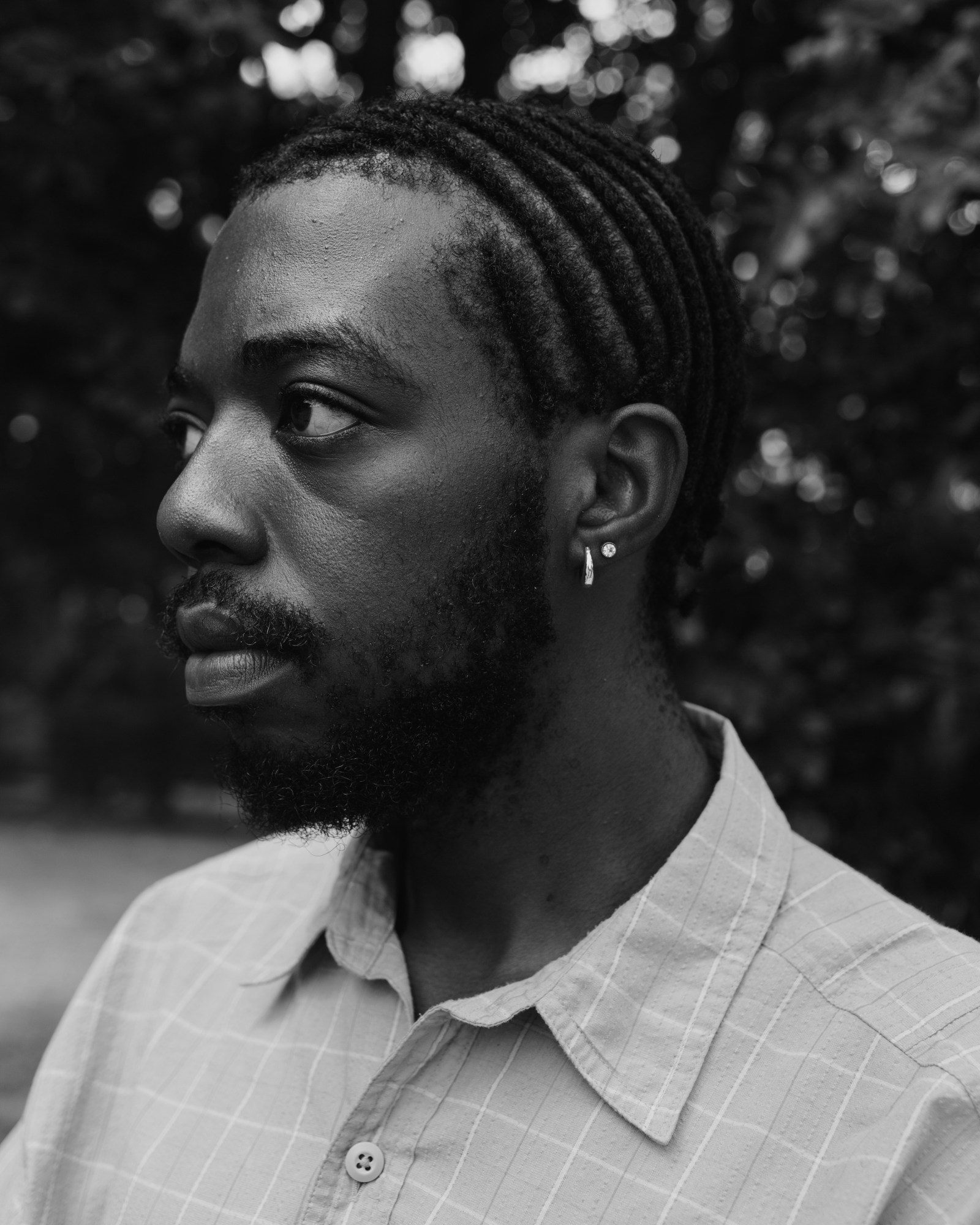 Close up of a man in a check shirt.