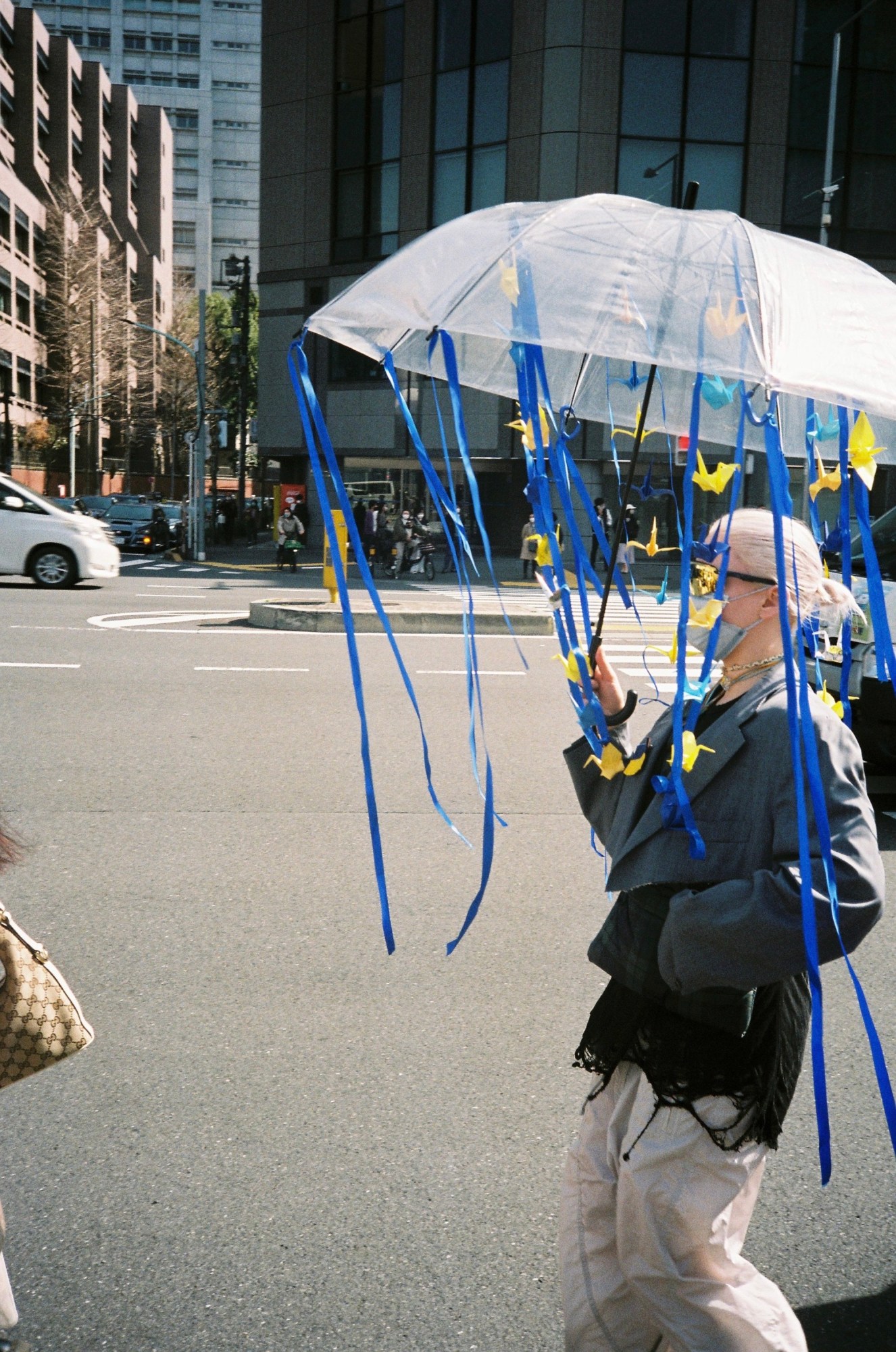 Woman with ribbons attached to her umbrella.