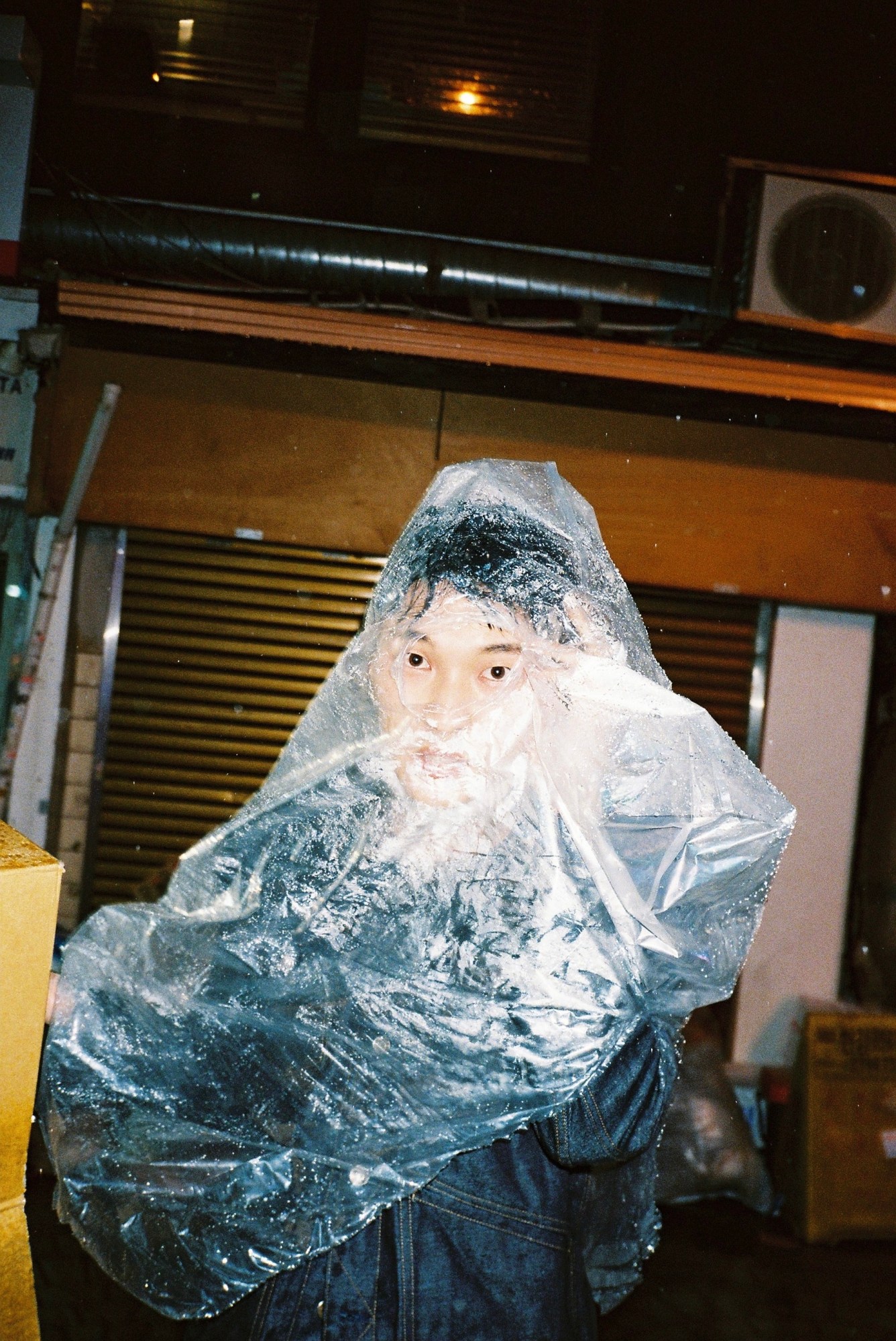 person wearing a plastic bag as a cover.