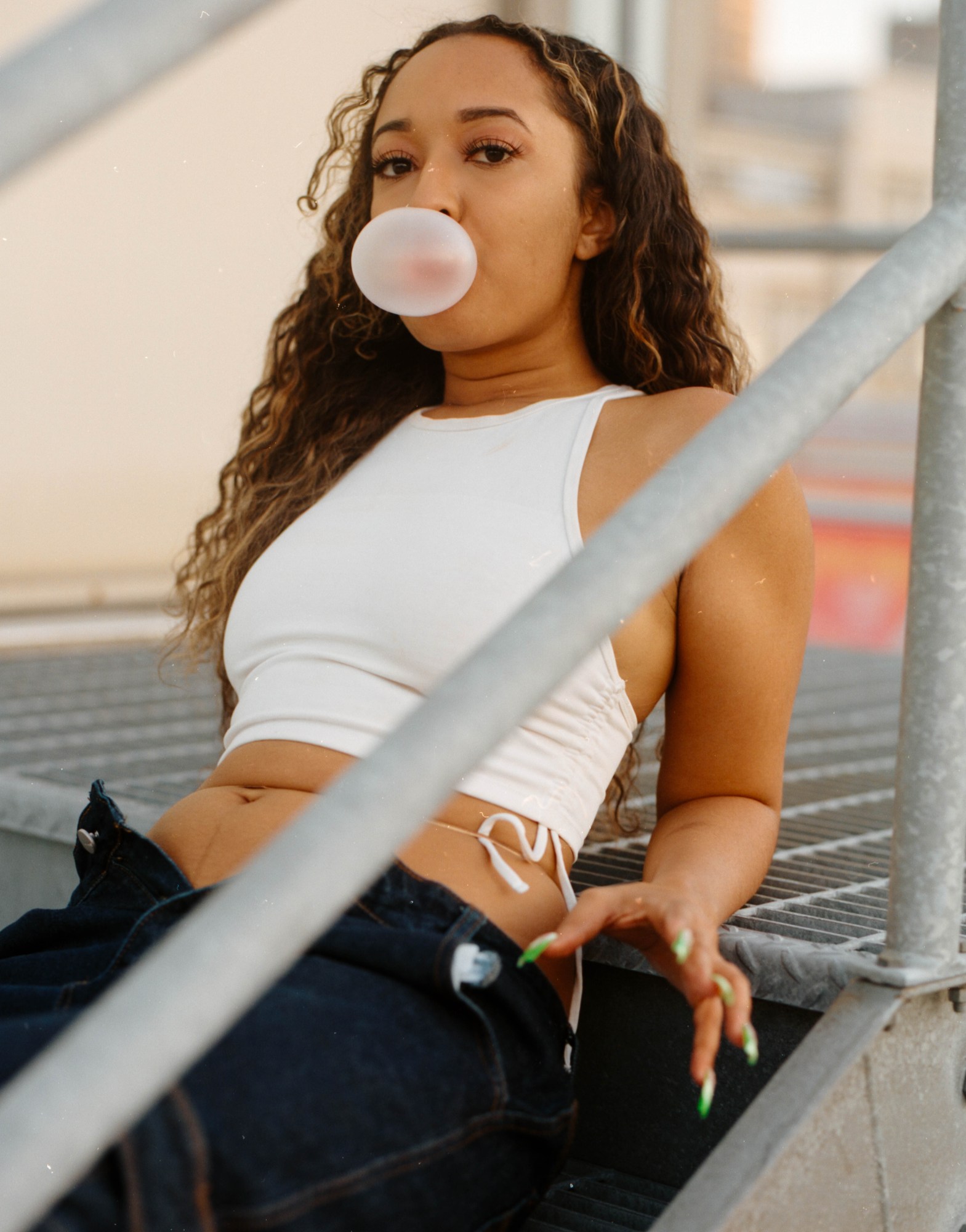 girl blowing a bubblegum bubble