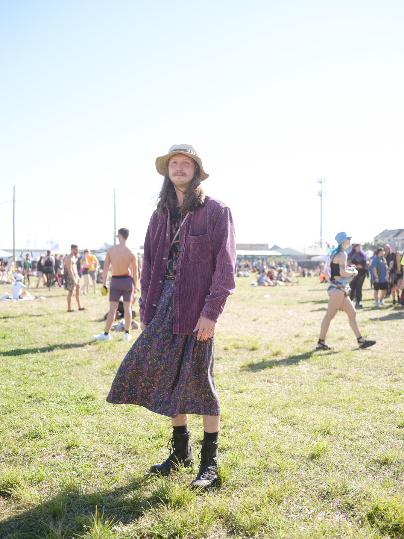 jackson posing in the grass at buku music + arts festival in new orleans