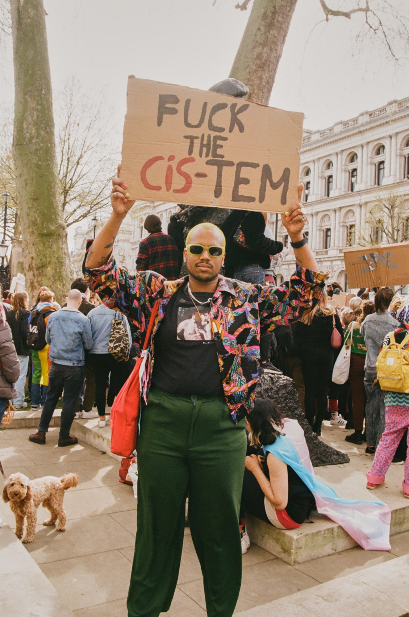 Protester holding a sign saying 'fuck the cis-tem' at the ban trans conversion therapy protest at Downing Street, London.