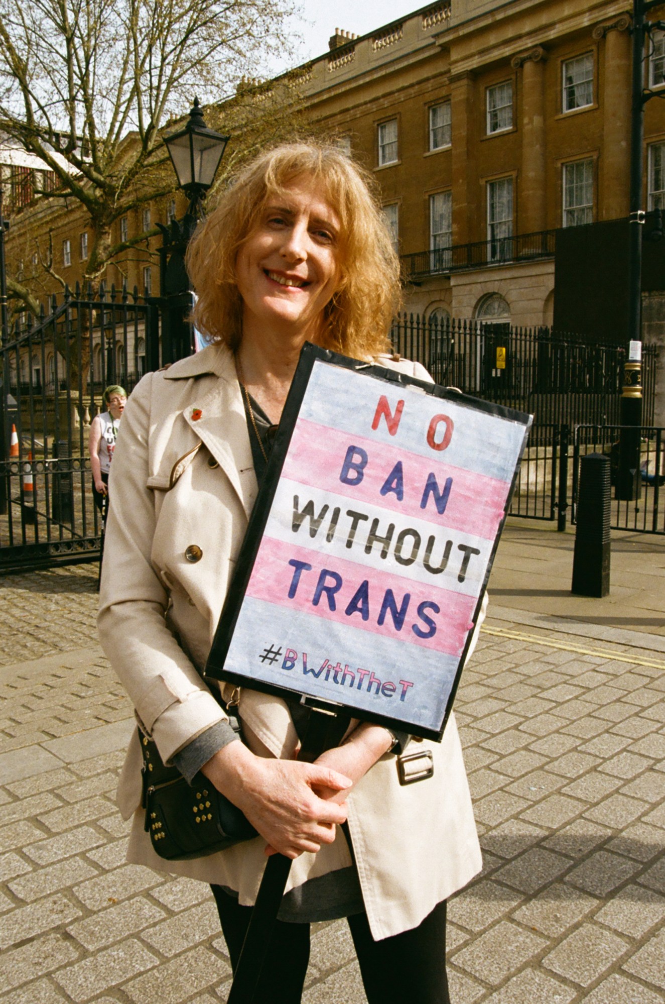 Protester holding a sign saying 'no ban without trans #BWithTheT' at the ban trans conversion therapy protest at Downing Street, London.