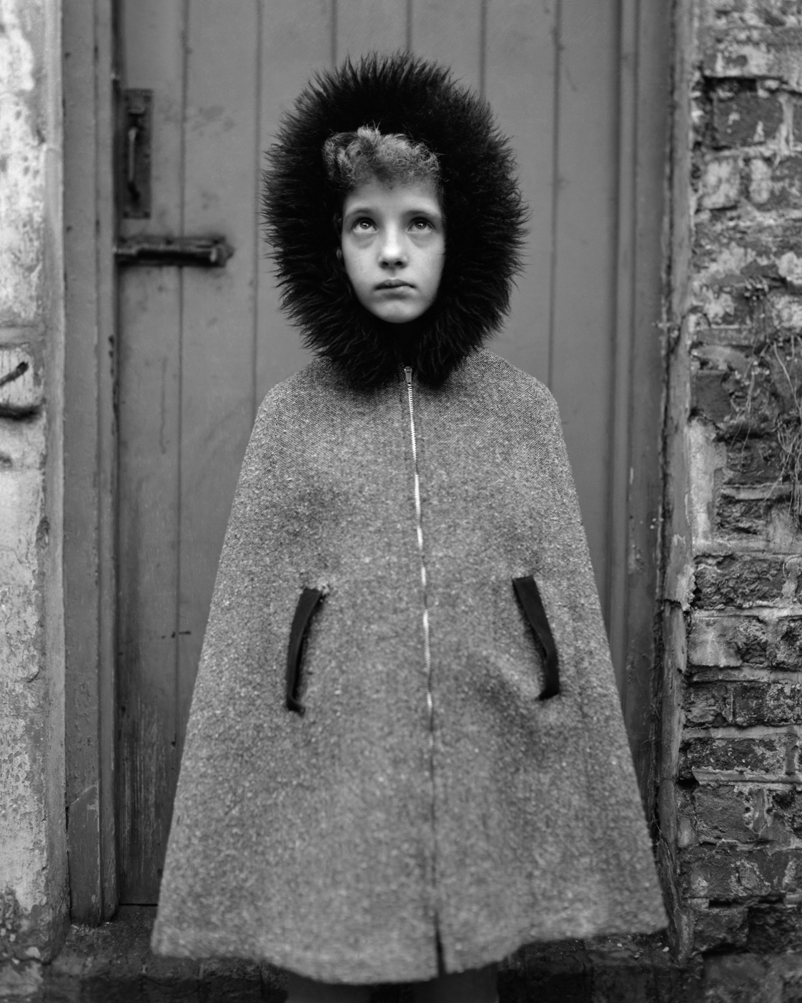 a young girl in a hooded jacket