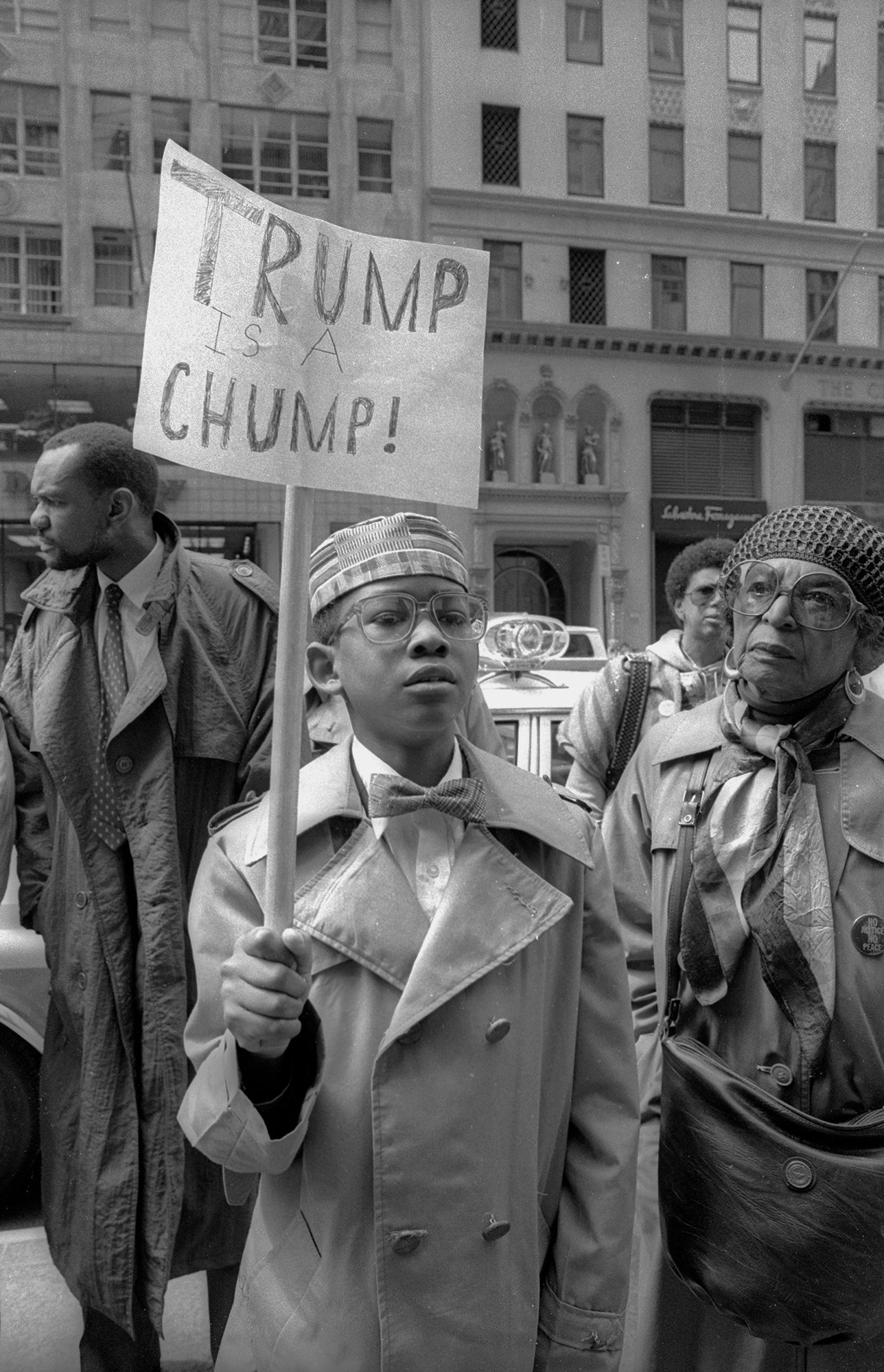 portrait of a protestor with a sign reading 'trump is a chump!'