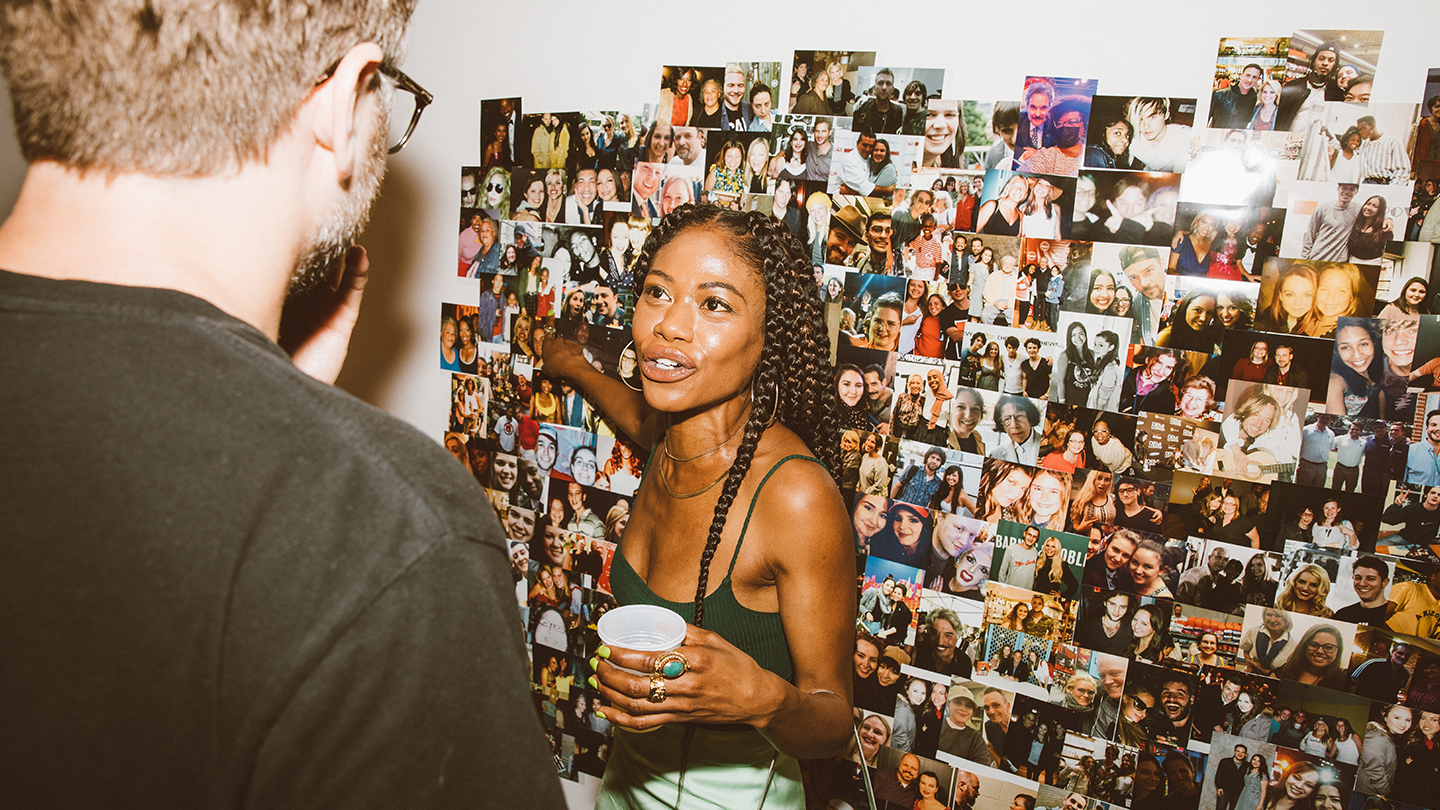 an exhibition-goer points to one of the photos displayed for 'autograph hound'