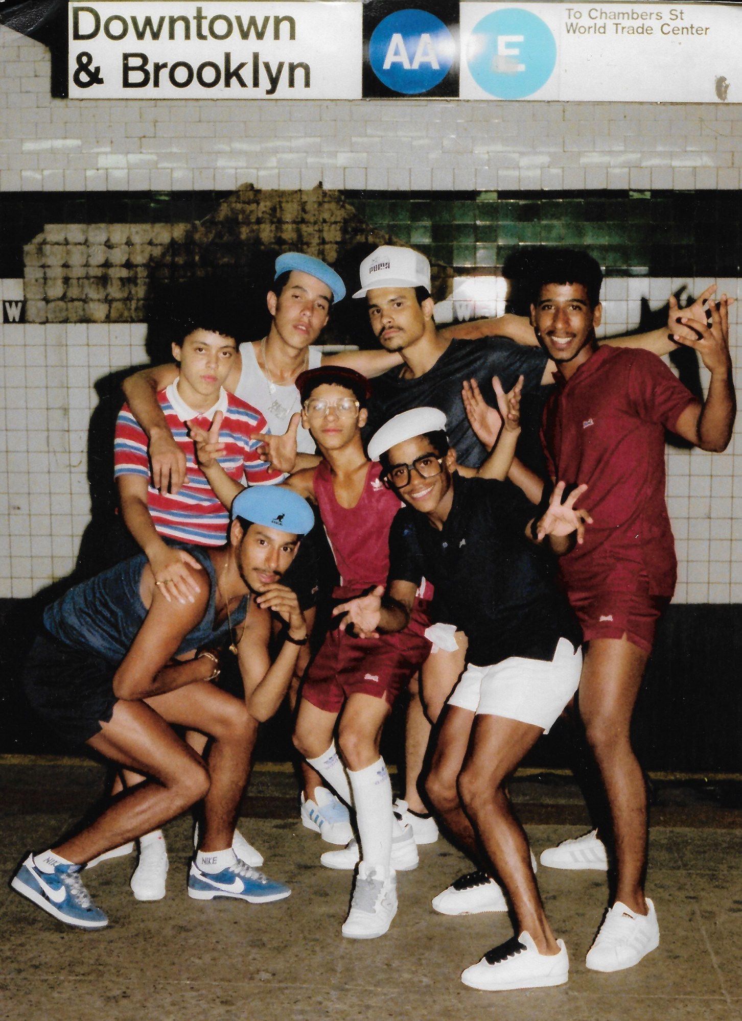 Young men wearing bucket hats and sneakers while posing for a group photo in New York City.