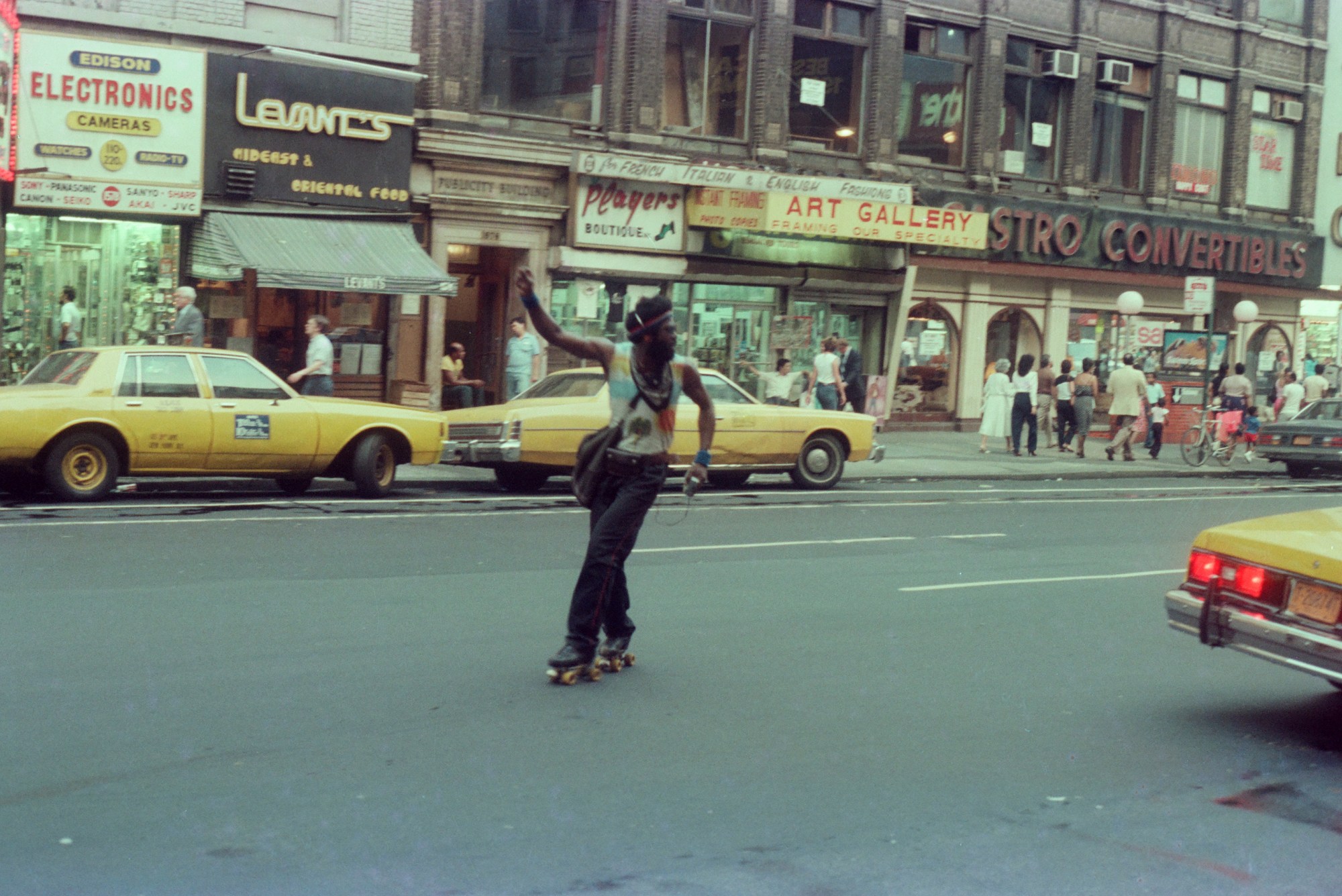 A man wearing rollerskates and headphones in 1980 in New York City.