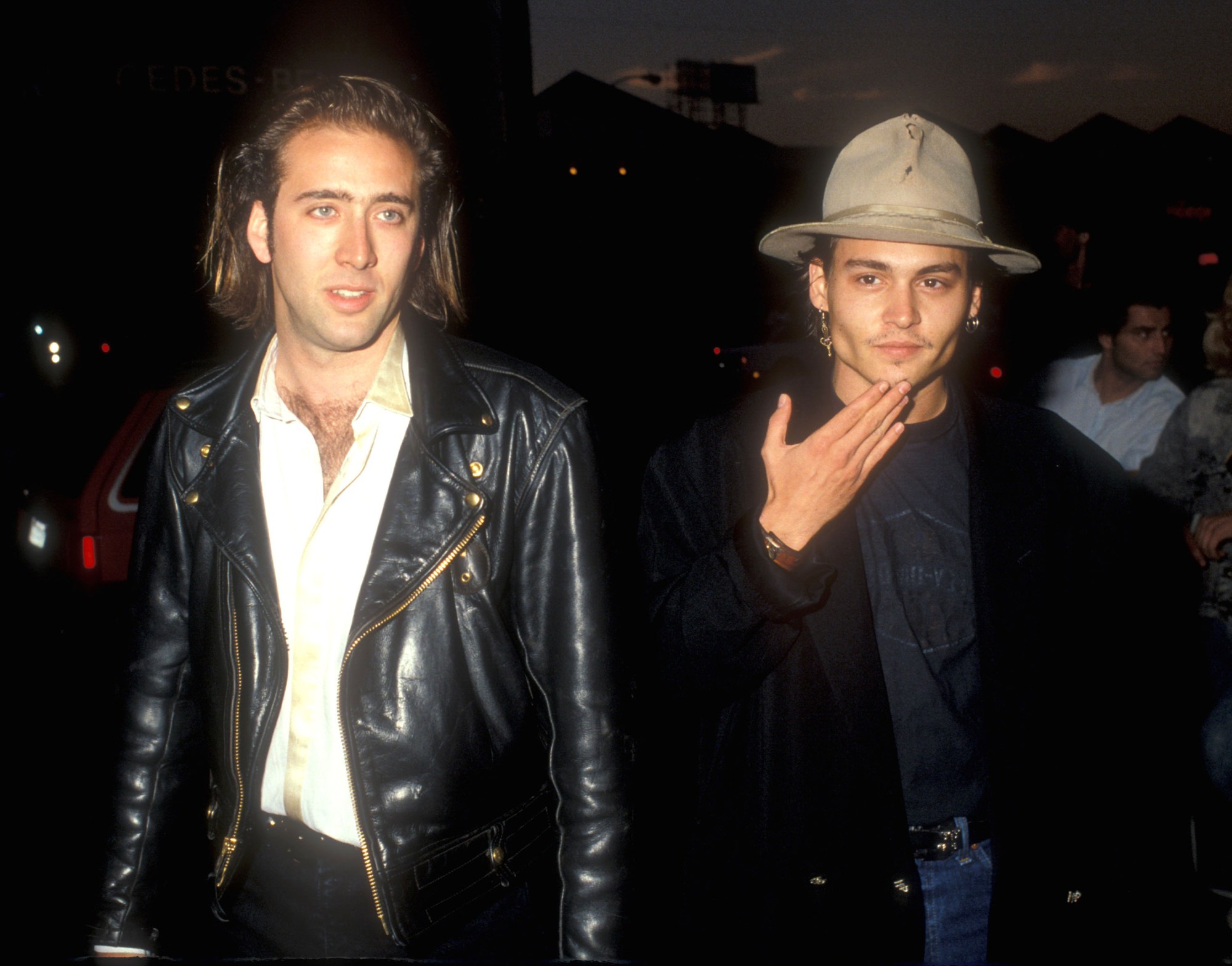 nicolas cage in a leather jacket with johnny depp at a movie premiere 1988