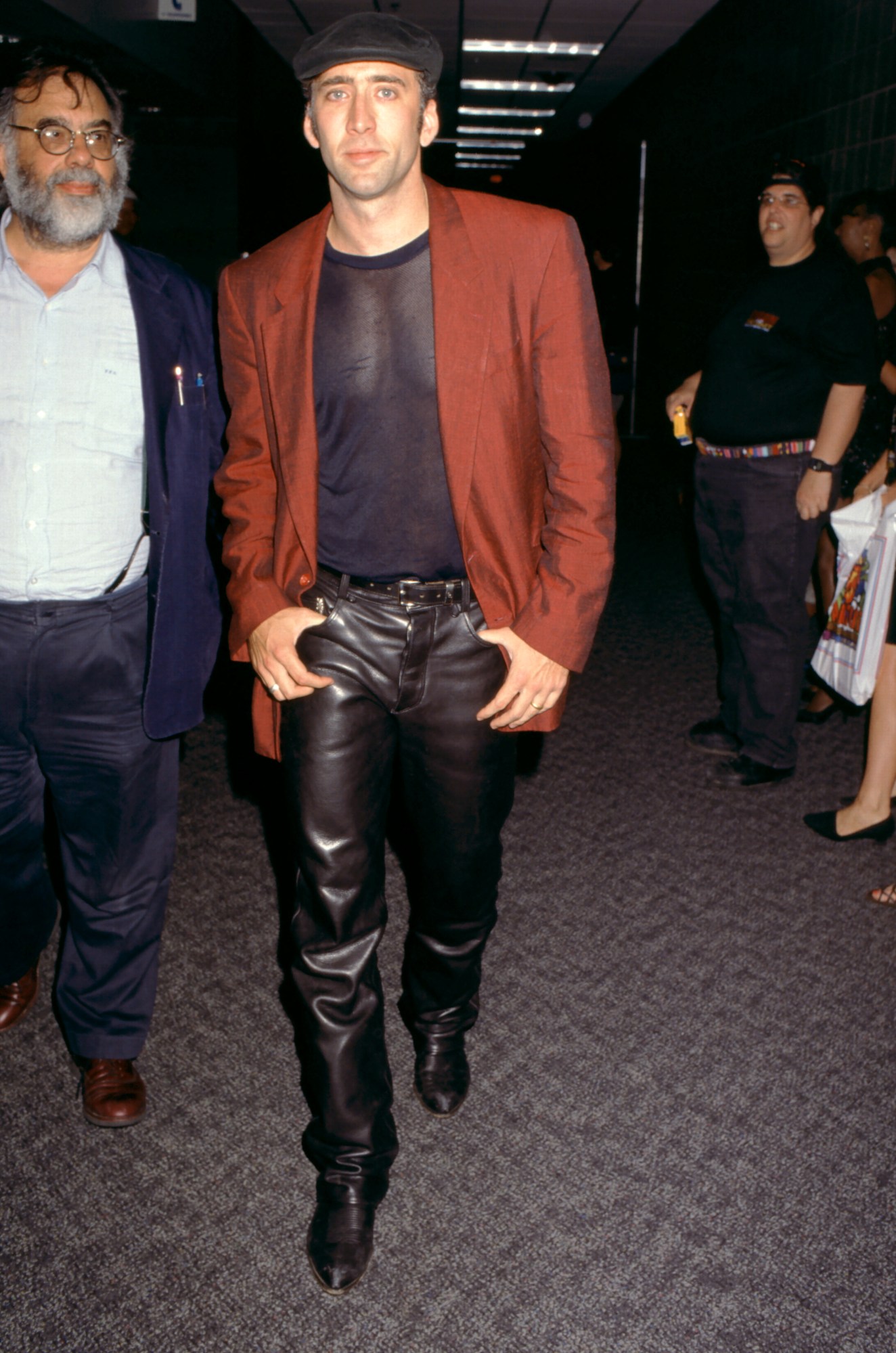 nicolas cage wearing a mesh shirt, leather pants and red jacket in las vegas 1995