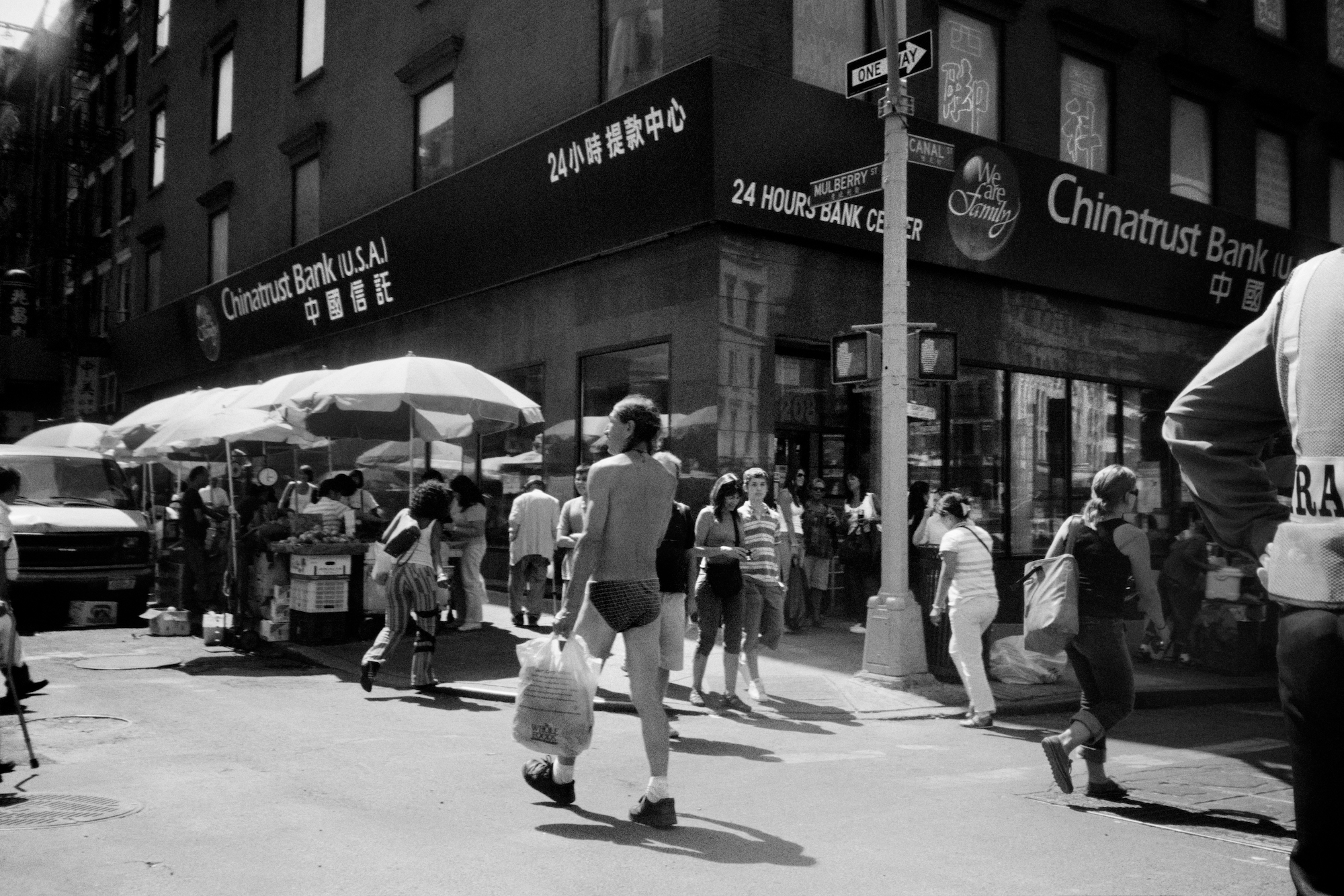 a man walking down a new york street in briefs and carryin groceries by jason dill