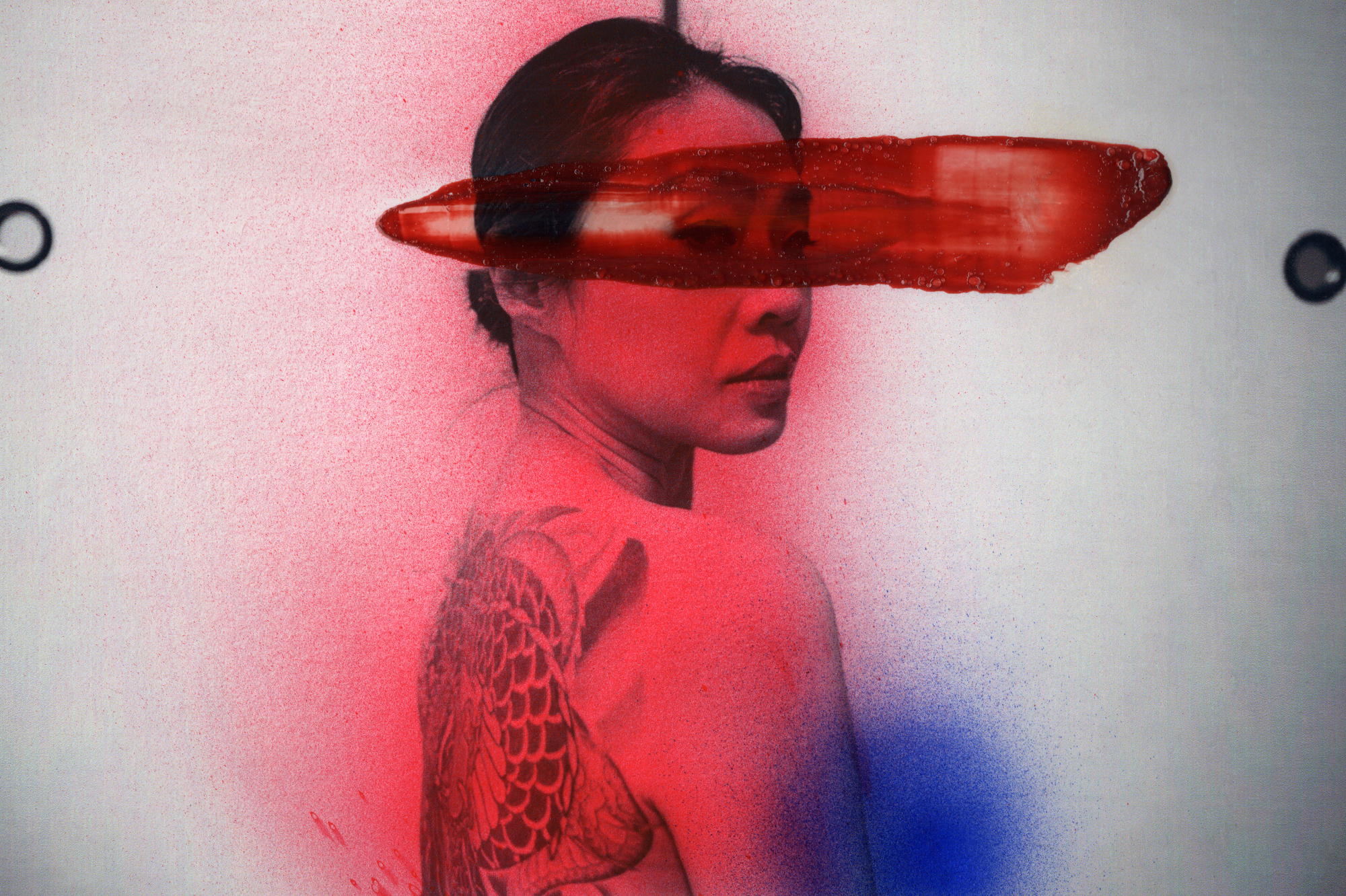 chloe jafé tattooed yakuza woman looking over her shoulder, with watercolour painting over her face