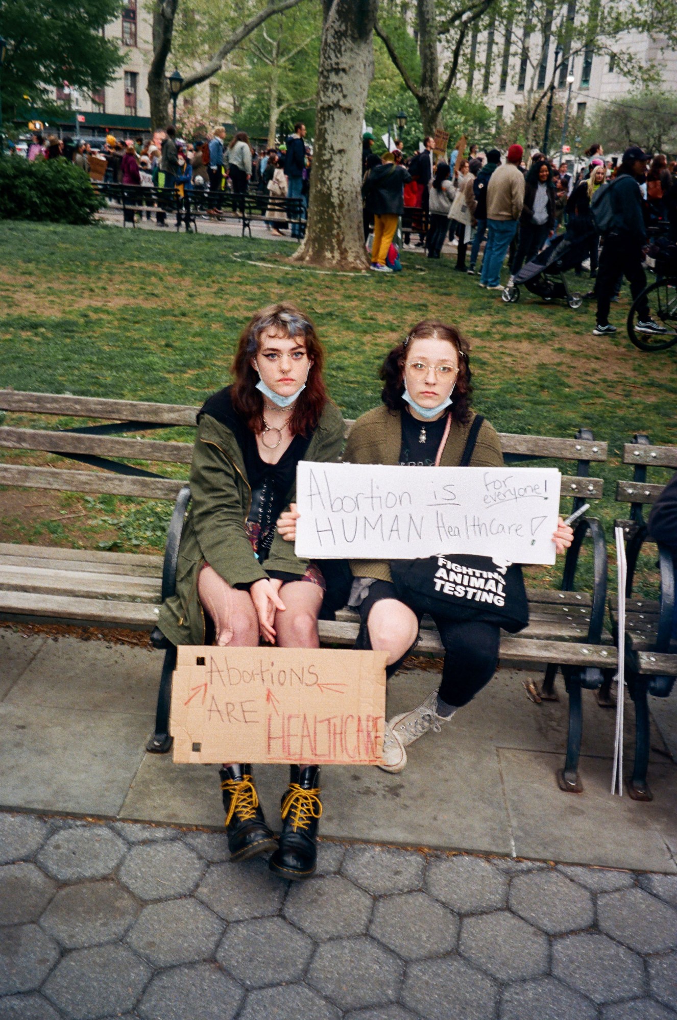 two abortion rights protestors sitting on a bench in foley square