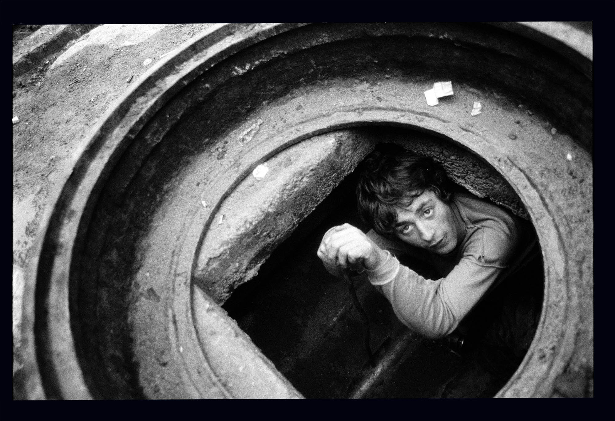 A young boy looking up from underground.