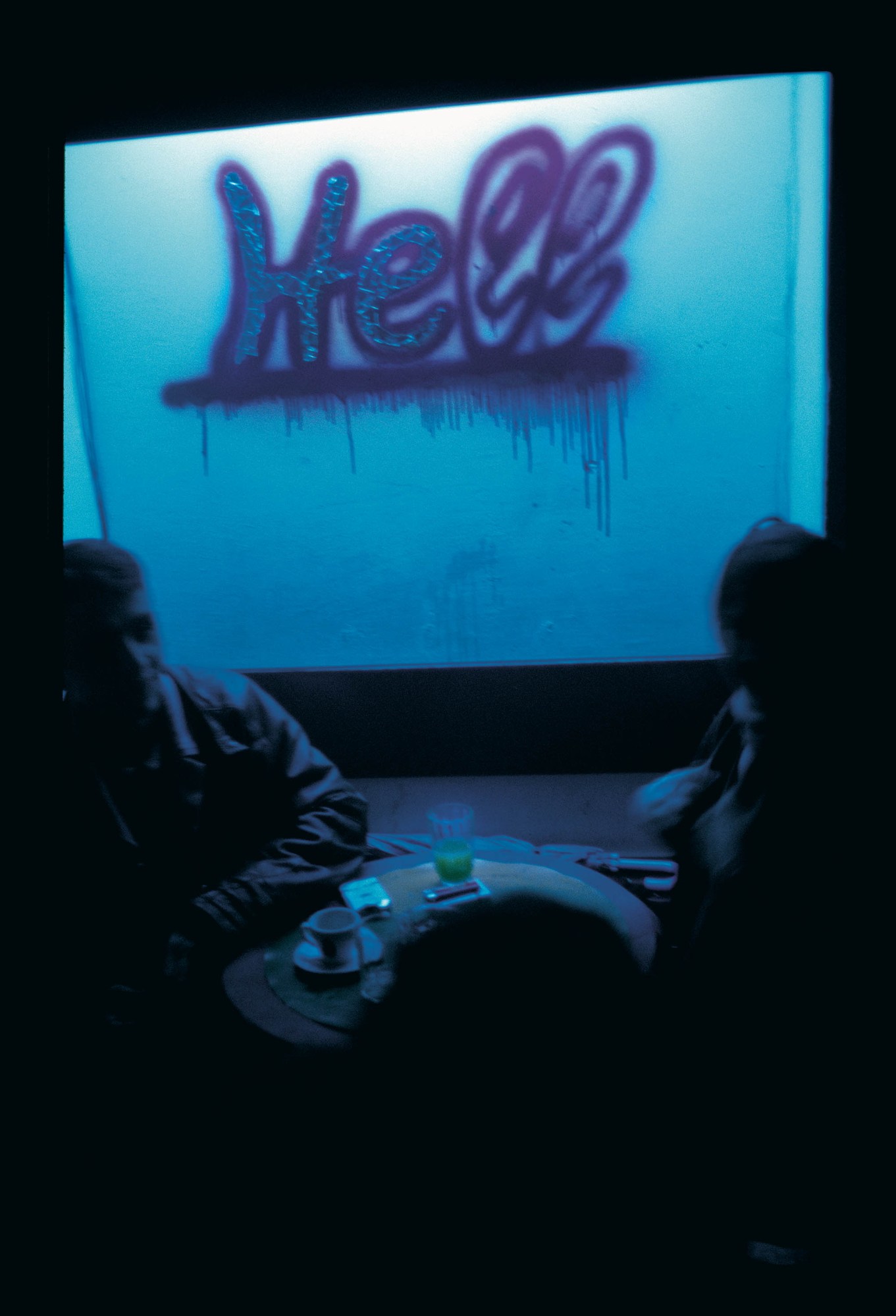 A bar in Eastern Europe during the 90s with the word HELL written on the wall.