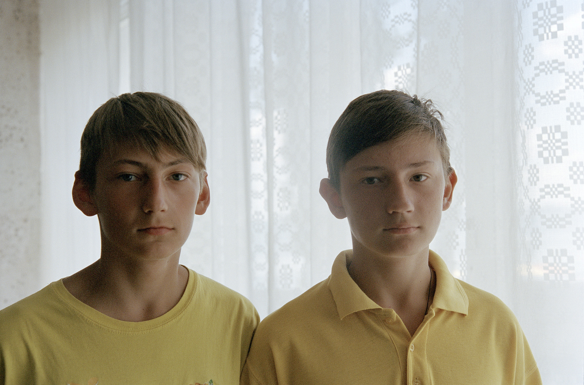 Two teenage boys dressed in yellow.