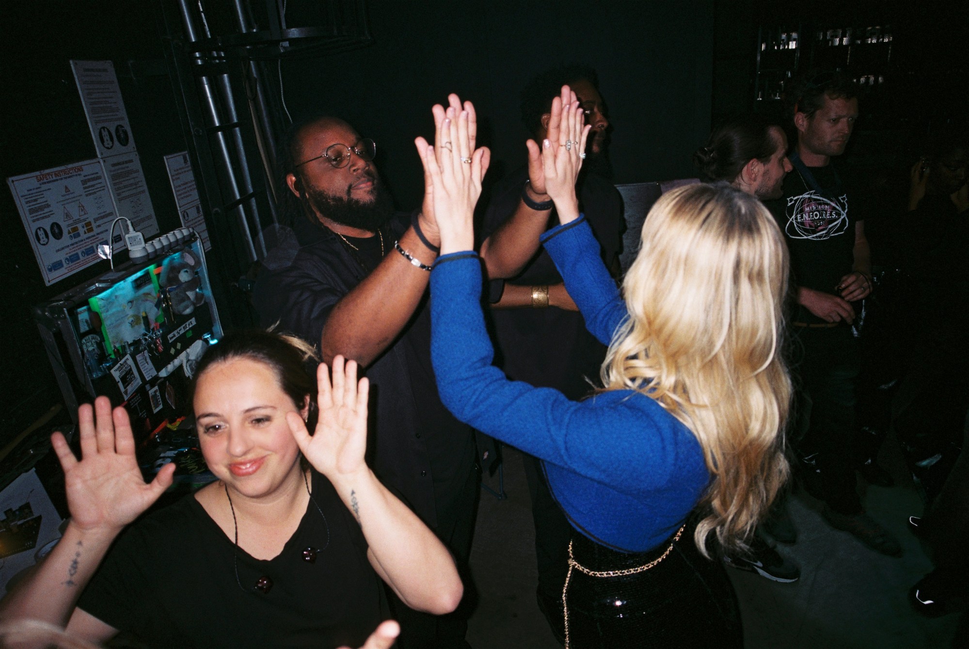 Angele and her team high-fiving before her concert