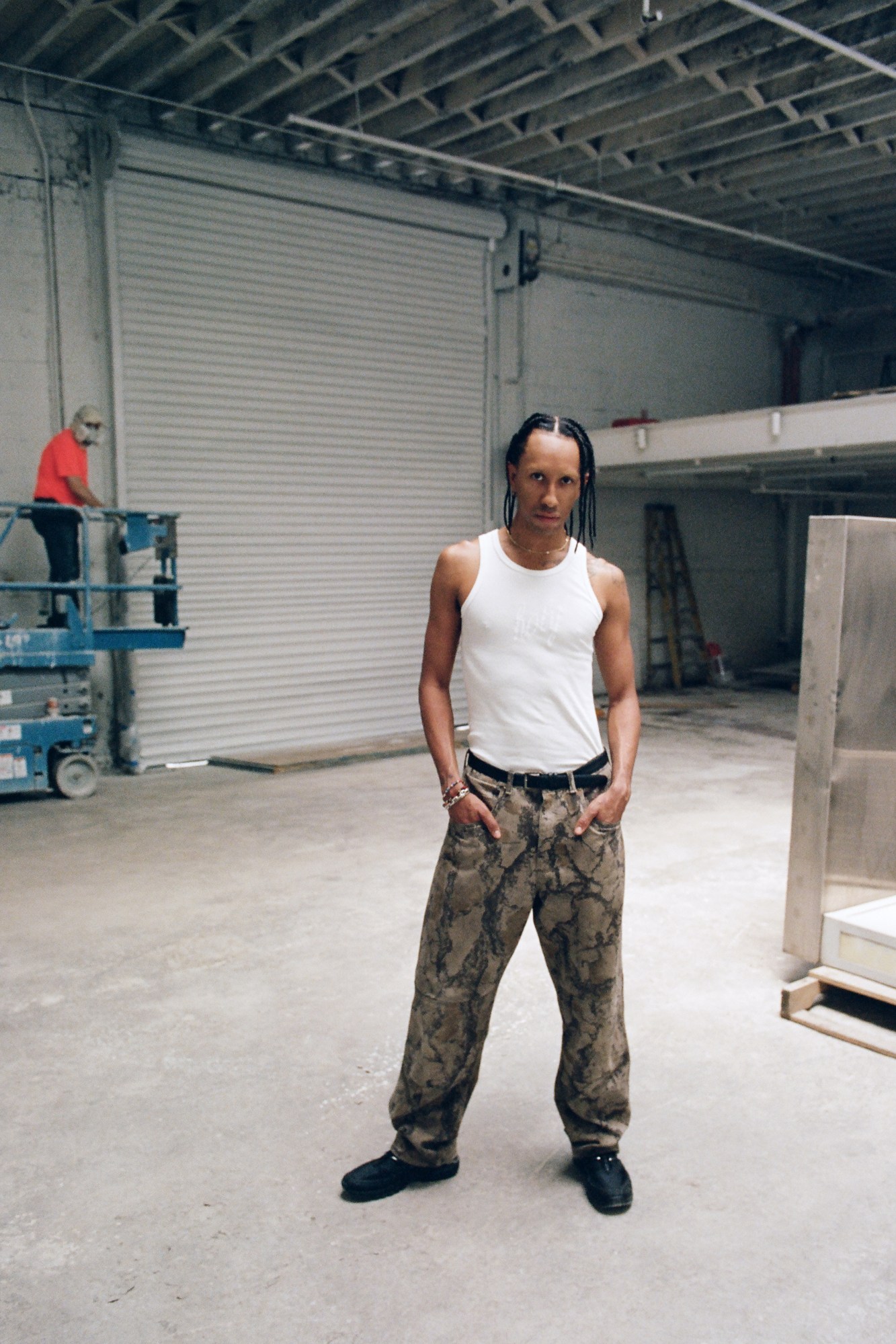 Miles Greenberg wearing camo pants and a white tank top.