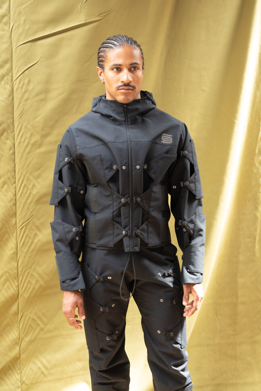 A model wearing a black Gore-Tex look from Olly Shinder's CSM graduate collection