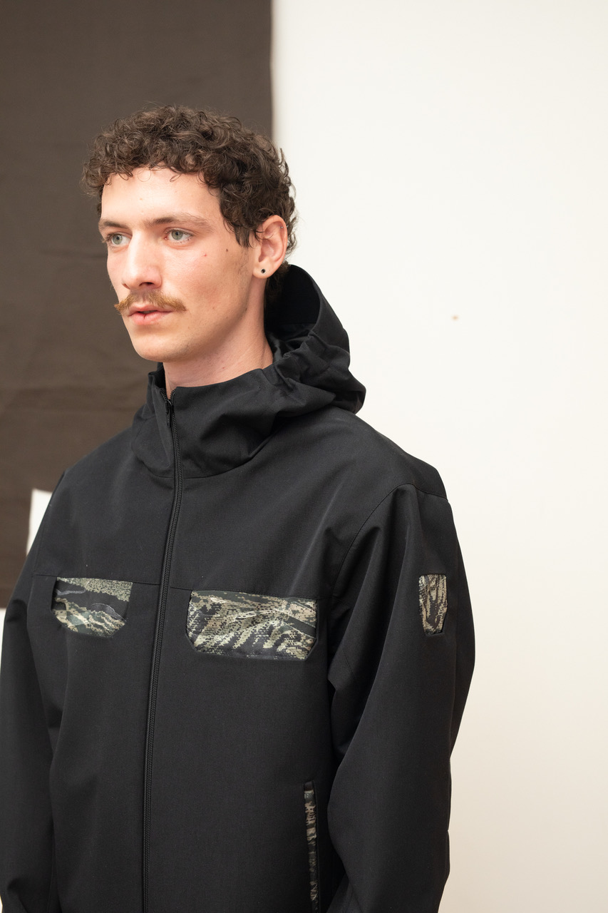 A model wearing a black Gore-Tex look from Olly Shinder's CSM graduate collection