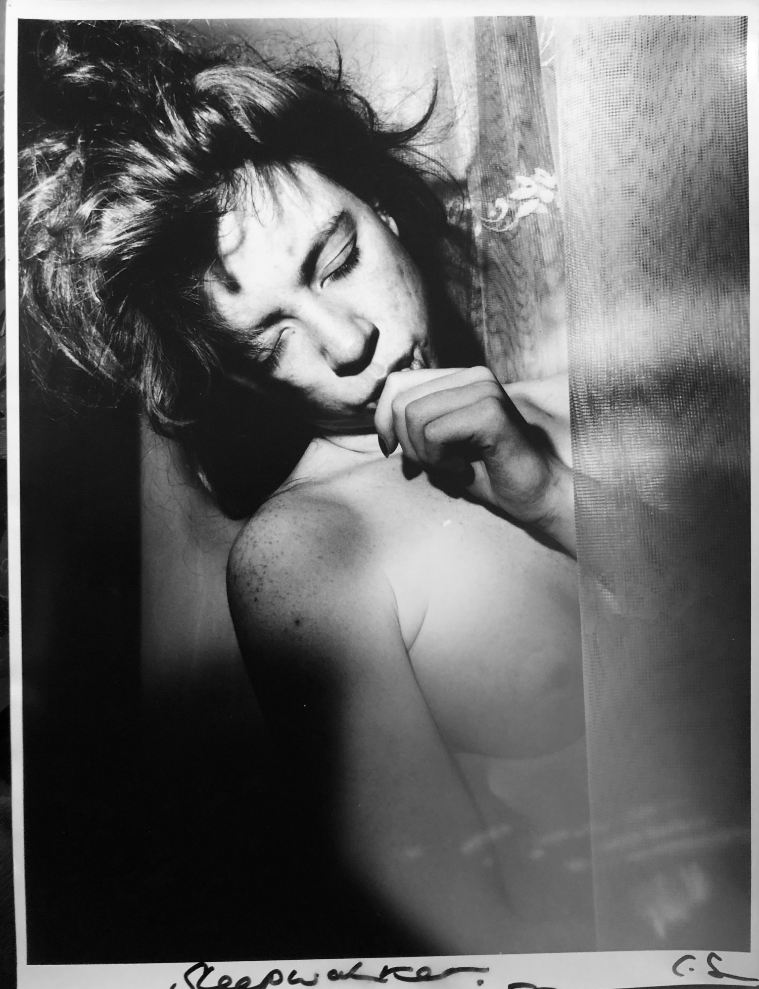 black-and-white image of sleeping topless woman