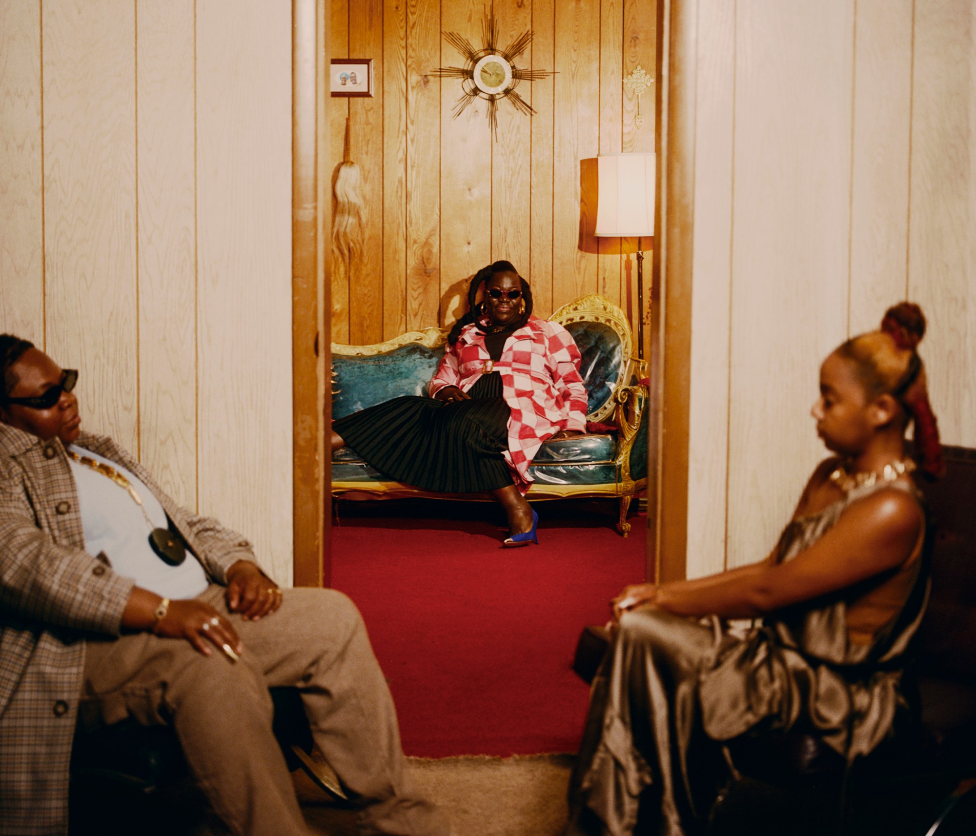 three black women sitting in chairs at home photographed by kendall bessent for chucha studios