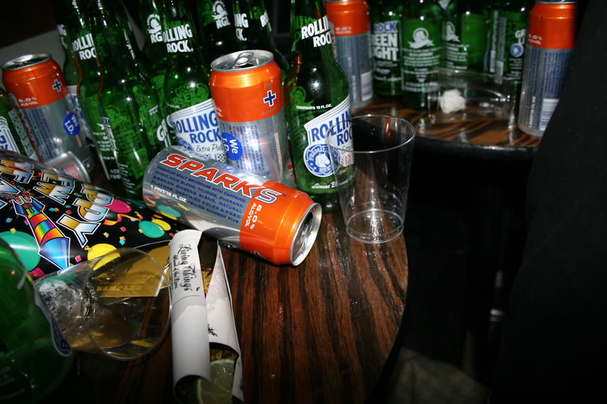 sparks cans and rolling rock bottles on a table photographed by the cobrasnake