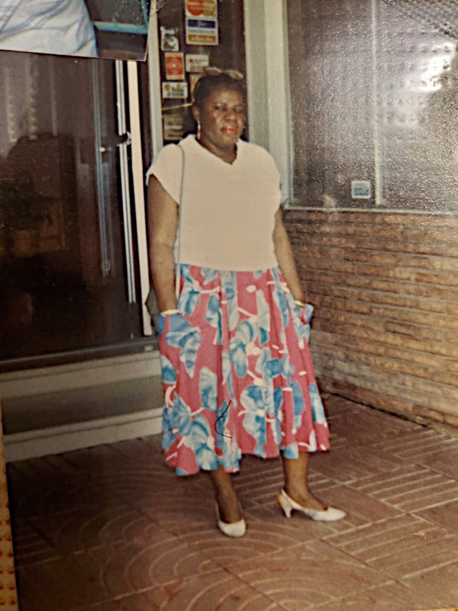 Photograph of Rosette Sabbat standing outside her home.