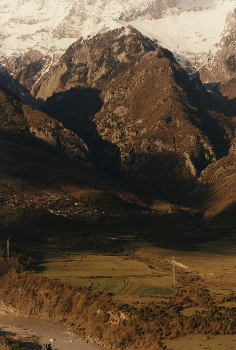 The mountain range and fields next to the river Vjosa in Albania