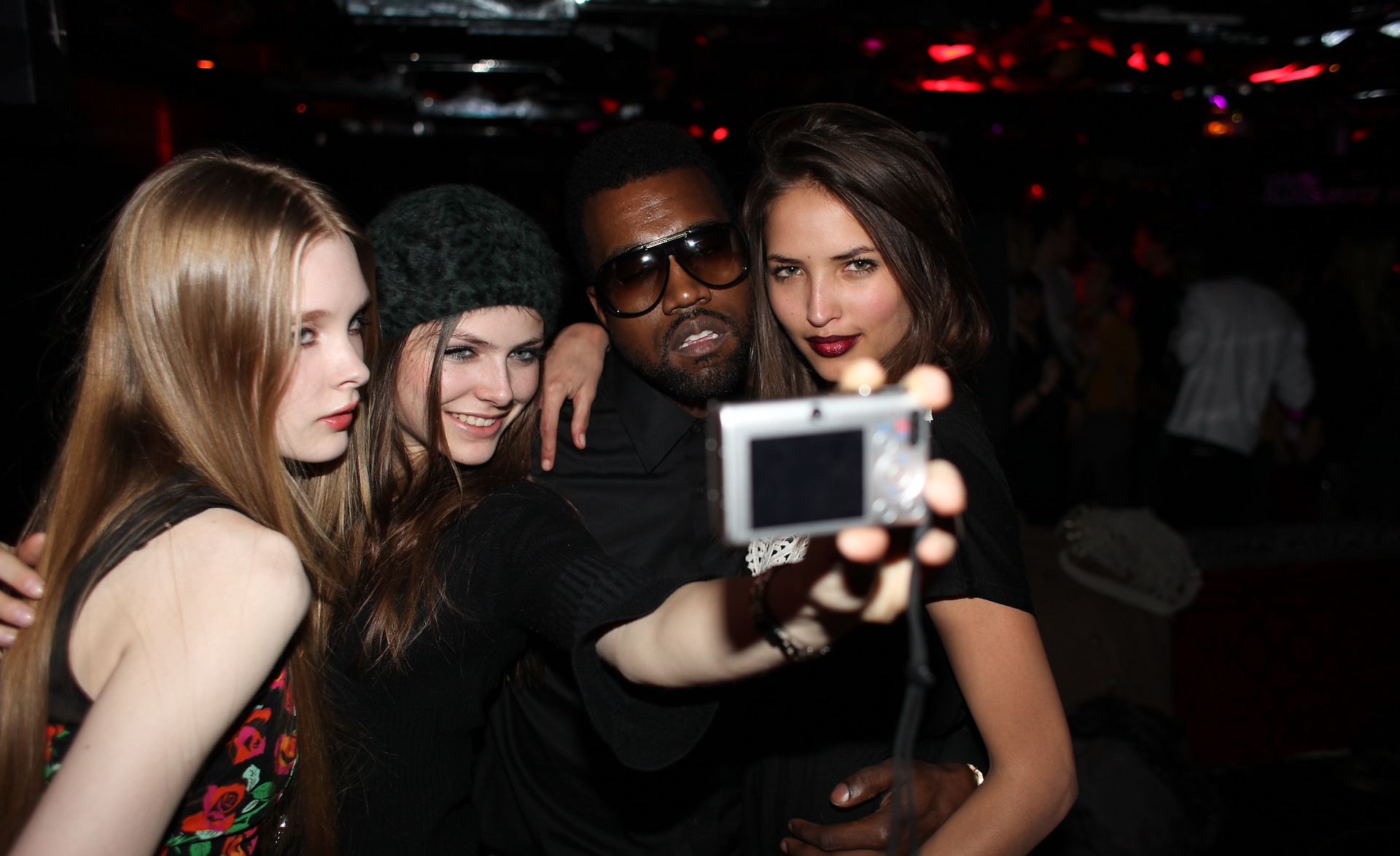 models taking a selfie on a digital camera with kanye west photographed by the cobrasnake